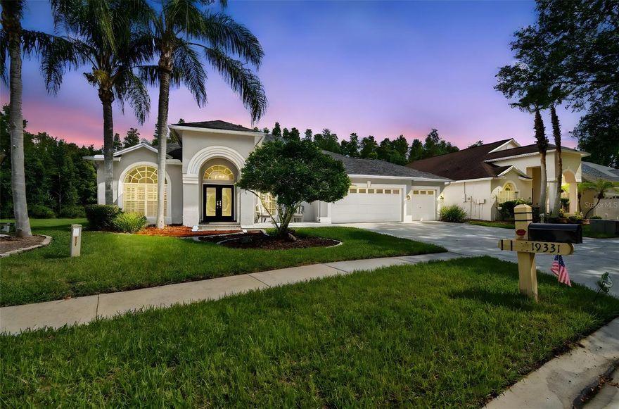 Welcome to your dream home in the award-winning community of Villa Rosa, located in the highly sought-after Steinbrenner High School district! Nestled on a quiet street and surrounded by mature trees and conservation views, this meticulously maintained 4-bedroom, 3-bathroom home with a bonus room and oversized 3-car garage offers the perfect blend of luxury, function, and Florida lifestyle living.
From the moment you arrive, the curb appeal will impress with soffit lighting, mature landscaping, a paved front porch seating area, and glass double entry doors with a transom window that fill the grand foyer with natural light. Inside, in the main areas, you will find premium wood-grained tile, and in three of the bedrooms, luxury vinyl plank flooring (LVP), and designer touches like plantation shutters, art niches, and high ceilings.  To the left of the foyer is the formal living room—bright and inviting with expansive windows. To the right is a spacious formal dining room, ideal for hosting gatherings. The heart of the home is the HUGE gourmet kitchen, which features granite countertops, a prep island, stainless steel appliances (including a double oven range and a refrigerator with built-in Keurig), instant hot water tap, glass tile backsplash, breakfast bar, pantry with wood shelving, and an eat-in dining space.  The adjacent family room is warm and welcoming with a gas fireplace, custom built-ins, and triple pocket sliders that open the entire wall to the screened lanai—perfect for indoor-outdoor entertaining.  The spacious primary suite, located just off the family room, offers a peaceful retreat with double door entry, dual pocket sliding glass doors, additional windows for natural light, two walk-in closets, and high ceilings. The primary bath boasts separate vanities, granite countertops, a garden tub, walk-in shower with vintage-style glass block, tile flooring, and a private water closet.  Past the kitchen and down the hall are three generously sized guest bedrooms. Bedroom 2 features a walk-in closet and plantation shutters. Bedroom 3 includes a bay window, crown molding, and a walk-in closet. Bedroom 4 offers a large double closet and ensuite pool bath with a walk-in shower and recent upgrades that offers easy access to the lanai. The hallway also leads to the laundry room with upper cabinets, newer front-load washer and dryer, and plumbing for a utility sink.  Upstairs, you'll find a massive bonus room, currently set up as a home theater with stadium seating that includes seven electric reclining chairs, built-in surround sound, projector and screen, A/V equipment, movie posters, blackout curtains, and French doors that open to a private balcony deck with views of the conservation area.  Back on the first floor, step outside your sliding glass doors to your private oasis featuring a zero-entry saltwater pool with pebble tech finish, rock waterfall, paved deck, and oversized screened enclosure. Enjoy the peaceful conservation views and mature trees in your expansive yard, along with seeing several deer mornings, and evenings—perfect for relaxing or entertaining. Villa Rosa offers community amenities including tennis, pickleball and basketball courts, sand volleyball, a playground with a covered shelter, and is conveniently located near top-rated schools, dining, shopping, and major highways.