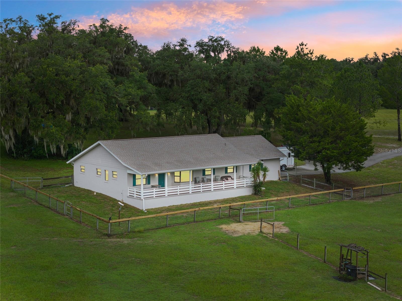 Welcome to peaceful, private living in Rolling Oaks Estates! This beautifully maintained 3-bedroom, 2-bathroom home sits on 10 FENCED ACRES and offers the perfect setup for horse enthusiasts. Need ACCESSABILITY? This home has it! Built in 2000 and updated with a NEW ROOF in 2021 and a NEW HVAC in 2023, the home boasts 1,920 sq ft of living space with durable laminate flooring throughout and carpet in the bedrooms. The spacious kitchen features a large island and northeast-facing views that are simply spectacular from both the kitchen and dining areas. Bedroom 3 offers FELXABILITY as a guest room, den, or office (no closet).
Enjoy the outdoors from the newer COVERED FRONT PORCH, finished with cool-touch pool decking material perfect for barefoot comfort on warm Florida days. The property is a working horse farm, and includes a 2-stall horse BARN with electric, and two fenced pastures with board, wire, and electric fencing. Fans in the barn do not convey. Please do not feed or pet the horses on site.
Located in a serene 11-home community with an annual HOA of just $350, this A1-zoned gem offers both function and freedom for your equestrian lifestyle.