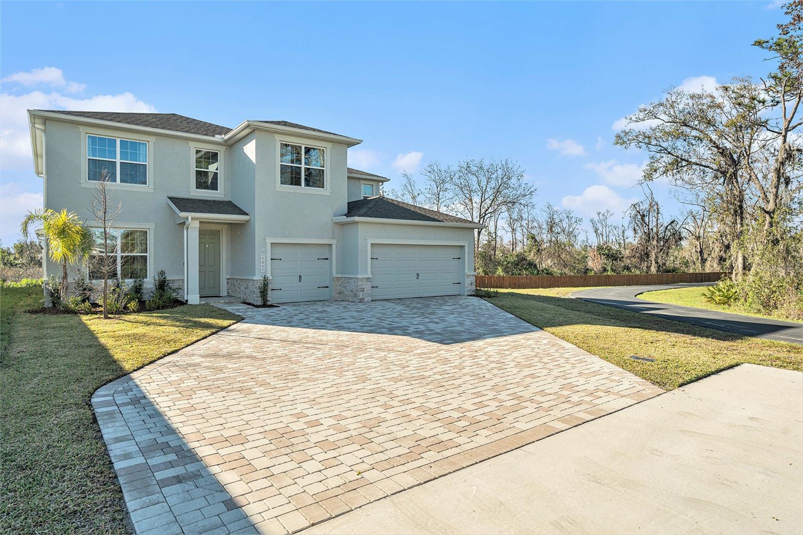 Welcome to comfort, flexibility, and refined living in the heart of Willow Reserve! This 2023-built DR Horton Jordin II model blends modern sophistication with everyday function, thoughtfully designed for multigenerational households, entertainers, and growing families alike. Located on a premium corner lot, this home features a Smart Home system, a rare oversized 3-car garage, and a spacious paved driveway—offering curb appeal and convenience from the start. Step into a bright and welcoming foyer that opens to a flexible first-floor bonus room with French doors, ideal for a home office, formal space, or playroom. Just beyond, a private en suite bedroom makes the perfect guest suite or in-law quarters, offering comfort and privacy on the main level. A well-placed powder room adds everyday convenience. At the heart of the home is a chef-inspired kitchen with stainless steel appliances, a built-in oven, walk-in pantry, and abundant cabinetry—perfect for entertaining or everyday meals. The kitchen flows seamlessly into the dining and living areas, creating an open-concept layout designed for connection and comfort. Upstairs, discover a bonus room that’s ready to flex to your lifestyle—game night, movie room, gym—you choose! The primary suite is your personal retreat, located on the second floor and offering a spa-like ensuite bathroom with a large walk-in shower, soaking tub, and double vanities, plus dual walk-in closets for generous storage. Bedrooms 3 and 4 are also located upstairs, each with its own walk-in closet, and they share a well-appointed second-floor bathroom with a double vanity—perfect for busy mornings. The upstairs laundry room includes a utility sink and tons of cabinetry, making chores feel (almost) effortless. Step outside to a covered porch and peaceful backyard oasis, with a private side yard—ideal for relaxing, hosting, or enjoying Florida’s sunshine year-round. This home offers seamless access to the area’s top destinations! Busch Gardens Tampa Bay approx 8 miles | The Florida Aquarium approx 14 miles | Clearwater Beach approx 25 miles | Tampa Riverwalk approx 14 miles | Honeymoon Island State Park approx 23 miles | Tampa International Airport approx 18 miles | Wiregrass Mall approx 8 miles | Tampa Premium Outlets approx 6 miles, 3D MATTERPORT https://my.matterport.com/show/?m=8oDvNR38Y1q&brand=0