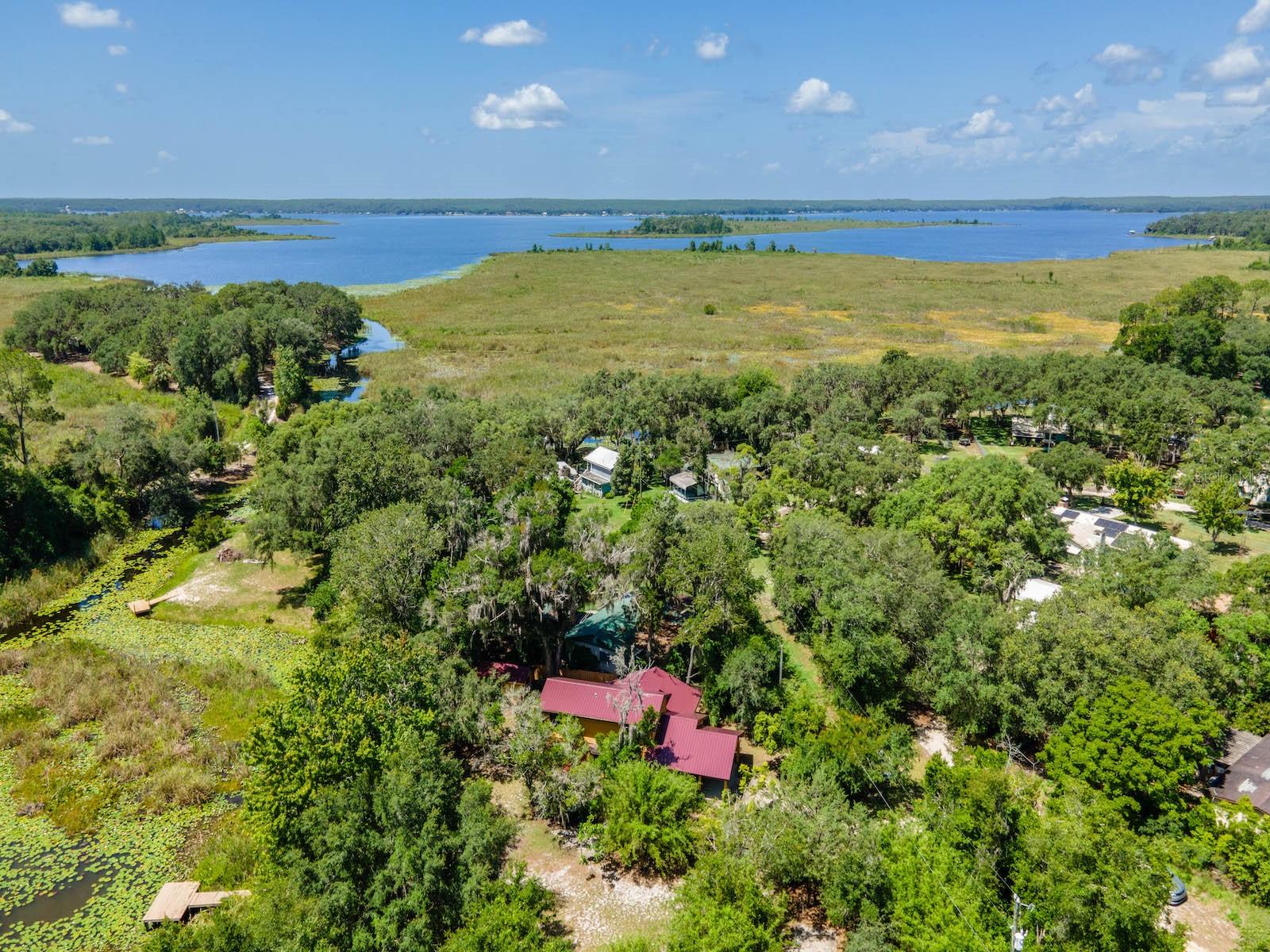 Waterfront Split-Level Home on Canal to Lake Kerr – 23610 & 23624 NE 154th Place Rd, Fort McCoy, FL 32134
3 Bed | 2 Bath | Office | 1,663 Sq Ft | Oversized Canal Lot
Nestled in the heart of Salt Springs, this unique split-level waterfront home offers direct access to Lake Kerr via a peaceful, oversized canal-front lot. Built in 1990 and situated on a quiet street, this charming residence offers 1,663 sq ft of living space with thoughtful features throughout.
Upstairs you'll find 2 bedrooms and 1 full bathroom, while the lower level includes 1 bedroom and 1 full bathroom along with the open-concept kitchen and living room. The kitchen features an island cooktop, ample cabinetry, generous counter space, and all appliances included. French doors open to a wood deck overlooking the canal, making indoor-outdoor living easy and enjoyable.
Additional interior highlights include a dedicated office with a large bay window—perfect for working from home with a view—as well as a spacious dining area family room combination, also featuring a large bay window that fills the space with natural light and scenic outdoor views.
Property Highlights:
3 Bedrooms | 2 Full Bathrooms
Dedicated Office with Bay Window
Dining Area with Bay Window
1,663 Sq Ft | Split-Level Layout
Open Kitchen with Island Cooktop & Appliances
French Doors to Waterfront Wood Deck
Oversized Canal Lot with Direct Access to Lake Kerr
2 Private Docks
Private Boat Ramp + Canal Storage Rack
8’x12’ Workshop + Utility Shed
Covered Front Parking | Fenced Yard
Just 10 minutes to downtown Fort McCoy for essentials like groceries, pharmacy, gas, and dining. A short drive brings you to Silver Springs for shopping (Walmart, Lowe’s, Bealls, etc.), and another 10 minutes to Ocala with vibrant nightlife, entertainment, and healthcare. Gainesville and the University of Florida are just 50 minutes away.
Surrounded by Florida’s finest nature, you’re moments from the Ocklawaha River, Ocala National Forest, and famous springs like Salt Springs, Silver Glen, and Juniper Springs. Perfect for fishing, boating, hunting, hiking, off-roading, and more.
This is a truly one-of-a-kind property in an unbeatable location — ready for new owners to enjoy year-round or as a relaxing getaway. Schedule your private showing today!
