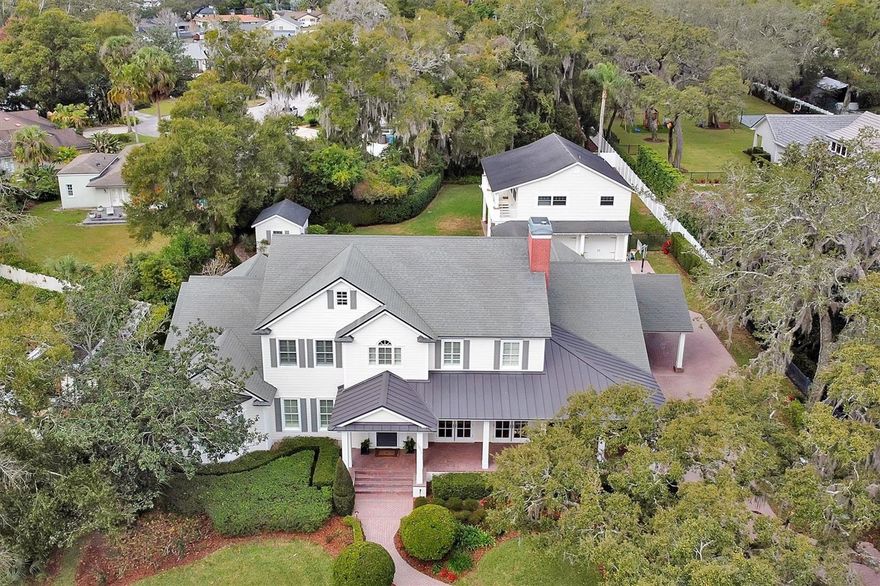 Stunning boat/ski lakefront home w 5,697sf on 1.5+- upland acres. 5 bed 4.5 bath w detached 1,100sf guest house over 3 car garage.  Minutes from downtown Winter Park/Park Ave upscale shopping & dining. 10-minute drive to downtown Orlando. Features: gourmet kitchen, pool/spa, summer kitchen, expansive storage, lakefront views.  The open concept kitchen is a true chef's delight featuring every accoutrement your heart would desire. A state-of-the-art refrigerator and freezer, double ovens, Ice maker, 2 wine/beverage fridges with a gourmet cook top, massive granite island and walk in pantry. This lovely kitchen is adjacent to the large family room and bonus room that each look out on to beautiful lake Sybelia. The downstairs flooring is a warm wide planked wood while the entrance and hall includes stunning large travertine tiles. The downstairs primary bedroom provides a private retreat of tranquility with breathtaking lake views as well as a large primary bathroom and walk in closet. You’ll find four substantial sized bedrooms and 2.5 baths upstairs with a bonus gamer room, study area and upstairs 2nd laundry room. The large front yard and lake views aren’t the only outdoor highlights the expansive property has to offer. You’ll enjoy entertaining and grilling in the large, covered summer kitchen or enjoy swimming in the beautiful crystal blue pool. It’s a gardeners delight with three large garden boxes and huge storage shed. There is also a large courtyard, half-court basketball court in addition to the shady large, grassed back yard. It’s truly a family home with tons of wonderful, usable and thoughtfully designed spaces with something for everyone to enjoy. Even your cars will be delighted with the oversized three car garage with extra space for a home gym as well. Come discover what living in Maitland is all about. This private and secluded street is a true gem as it offers privacy and an escape from bustling Orlando, yet minutes away from fine dining, top rated schools, parks and boutique shopping. This special home will provide the backdrop for many wonderful family memories to come. Schedule your private tour today and you’ll quickly see just what the epitome of luxury family living in gorgeous Maitland is all about.