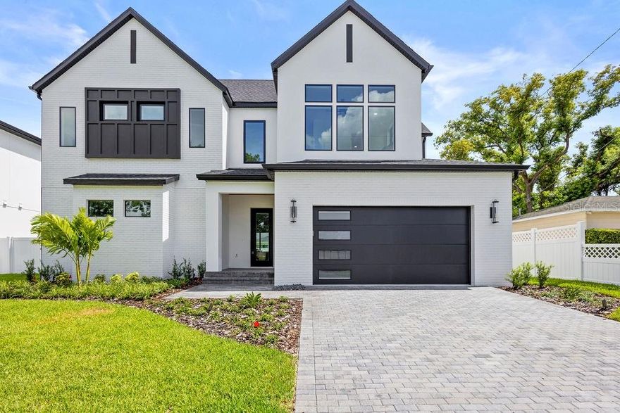 Contemporary sophistication meets South Tampa living in this new construction custom-built residence on a rare oversized lot just steps from Midtown and minutes to Downtown. Spanning 3,781 sqft (4,302 total), the home offers 5 beds, 4 full baths + 2 half, an oversized two-car garage, and convenient rear-alley access. Soaring 20-ft ceilings, an open layout, and walls of glass create bright, effortless flow. The chef’s kitchen boasts a quartz waterfall island, professional grade Bosch range, and glass-enclosed wine room. The first-floor primary suite impresses with dual closets, a spa bath, and private laundry. Upstairs features a loft, guest suite, and additional bedrooms plus secondary laundry. Outdoors, enjoy a fenced yard, covered patio, and multiple access points offering endless potential. Built with impact windows, spray-foam insulation, engineered hardwood flooring, and full smart-home wiring. Walk to Midtown’s shops and dining, with easy access to Armature Works, Water Street, and Downtown. Schedule your exclusive tour today before it’s too late!Contemporary sophistication meets South Tampa living in this new construction custom-built residence on a rare corner lot just steps from Midtown and minutes to Downtown. Spanning 3,781 sqft (4,302 total), the home offers 5 beds, 4 full baths + 2 half, an oversized two-car garage, and convenient rear-alley access. Soaring 20-ft ceilings, an open layout, and walls of glass create bright, effortless flow. The chef’s kitchen boasts a quartz waterfall island, professional grade Bosch range, and glass-enclosed wine room. The first-floor primary suite impresses with dual closets, a spa bath, and private laundry. Upstairs features a loft, guest suite, and additional bedrooms plus secondary laundry. Outdoors, enjoy a fenced yard, covered patio, and multiple access points offering endless potential. Built with impact windows, spray-foam insulation, engineered hardwood flooring, and full smart-home wiring. Walk to Midtown’s shops and dining, with easy access to Armature Works, Water Street, and Downtown. Schedule your exclusive tour today before it’s too late!