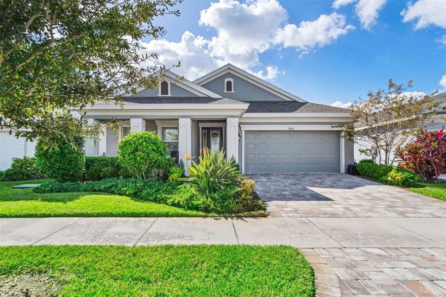 This lovely Waterset home offers 3 bedrooms plus den/office, 2 bathrooms and 2 car garage - all on a beautiful waterfront lot.  Enter through the leaded glass door into the foyer of this modern and elegant home.  Just beyond is the spacious and bright kitchen, dining room and family room combination that is perfect for entertaining.  The family room has sliding doors that open to an extended screened lanai overlooking a sparkling pond with stunning nightly sunset views. The upgraded kitchen is a cook’s dream with 42” cabinetry, quartz counters, island, gas range, stainless steel appliances and walk-in pantry.  The large owner’s suite has two walk-in closets and a luxurious ensuite bath with double sinks, garden tub, walk-in shower and separate water closet. Some of the many decorative upgrades include tile throughout the entire home (including bedrooms), crown molding, plantation shutters, French doors to the den/office, interior laundry room with utility sink, brick paver driveway, hurricane shutters and multiple Energy Star features.  The exterior features a 26x20 screened lanai with covered and open areas for relaxing or entertaining, brick paver decking, and a fabulous outdoor kitchen including gas grill, smoker and pizza oven.  All of this is surrounded by a fenced yard with a serene water view.  Waterset is a resort style community with clubhouses, café, heated pool, fitness center, parks, playgrounds, lake trails, frequent events and more (watersetfl.com for more info). You get all of this along with easy access to schools, shopping, restaurants, beaches and everything Tampa Bay has to offer!