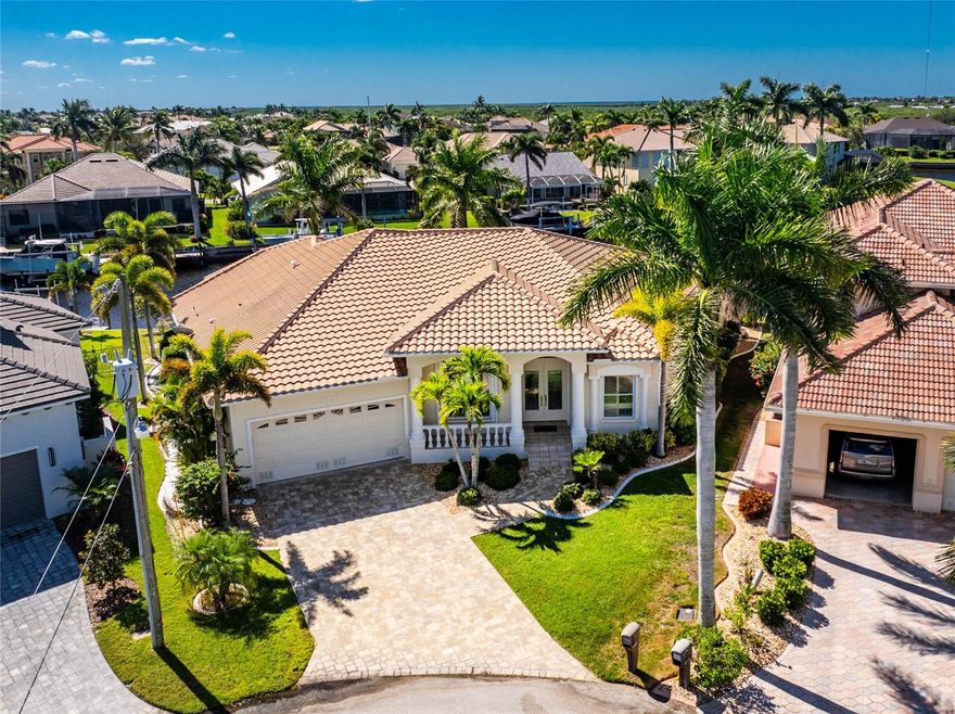 Live the life you have dreamed of in this spacious waterfront home in the golf and boating community of Burnt Store Isles. The minute you walk in the door, you will notice the stunning views.  Enjoy a day of golf, cool off in your pool and then jump on your boat at your private dock and head out to see an amazing sunset.  This home will not disappoint and is priced to sell quickly. There is plenty of space for family and friends and a perfect flow for entertaining both inside and out. The convenient location is close to schools, shopping, dining, entertainment, PG airport and all that Punta Gorda has to offer. The City of Punta Gorda maintains the seawall, the roof was replaced in 2023, the HVAC system in 2016 and the whole house has been plumbed with a Manabloc system. This home will exceed your expectations, and is priced to accomodate potential updating.  Don't miss this one, call for your private showing.  Transferrable flood policy available.