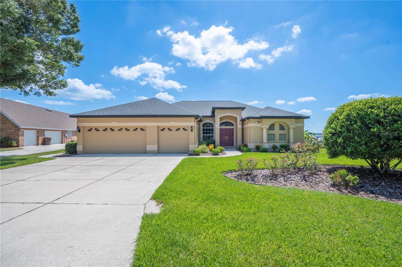 Welcome to this stunning 4-bedroom, 2.5-bath Tri-Plan home located in the highly sought-after Sandy Pointe community of Polk City, FL. Perfectly situated on a premier half-acre lot at the end of a cul-de-sac, this property offers privacy, tranquility, and breathtaking views of Big Lake Agnes. Known for its excellent fishing and boating, the lakefront setting provides a lifestyle of peace and recreation. Imagine sitting on your lanai watching sunrises in the morning and the moonrise at night reflected over the water. Step inside to discover soaring 11-foot ceilings in the formal living room, dining room, master suite, kitchen, and family room, creating an open and airy atmosphere. The home also features 9.2-foot ceilings in the additional three bedrooms, laundry room, and bathrooms for a spacious flow throughout. The formal dining room and formal living room both showcase cherry laminate flooring and double sliders leading out to the lanai with expansive lake views. The master suite includes double sliding glass doors overlooking the lake, his-and-her walk-in closets, and a luxurious bath with separate vanities. The kitchen boasts 40-inch cabinets, granite countertops (updated in 2020), and a breakfast nook with a large picture window and custom wood blinds. In the family room, enjoy a gas fireplace, custom window treatments, and sliders that open to the lanai and lake view. The oversized 24x24 screened lanai is perfect for entertaining, featuring two ceiling fans and a 220-volt outlet ready for a spa. Outside, enjoy a beautifully landscaped yard with lake-fed irrigation, four hose bibs, and plenty of space to relax. A highlight of this property is the 95-foot dock with a boat house, boat cradle, and sundeck, making lakefront living truly enjoyable. Additional features include a 3-car garage, a new air conditioning system (2016), and a new roof (2017), providing peace of mind. The home is part of a welcoming community with a private boat ramp and low HOA dues. With its serene setting, elegant features, and direct lake access, this property is a rare find. Don’t miss the opportunity to experience lakefront living at its finest on Big Lake Agnes—schedule your private showing today