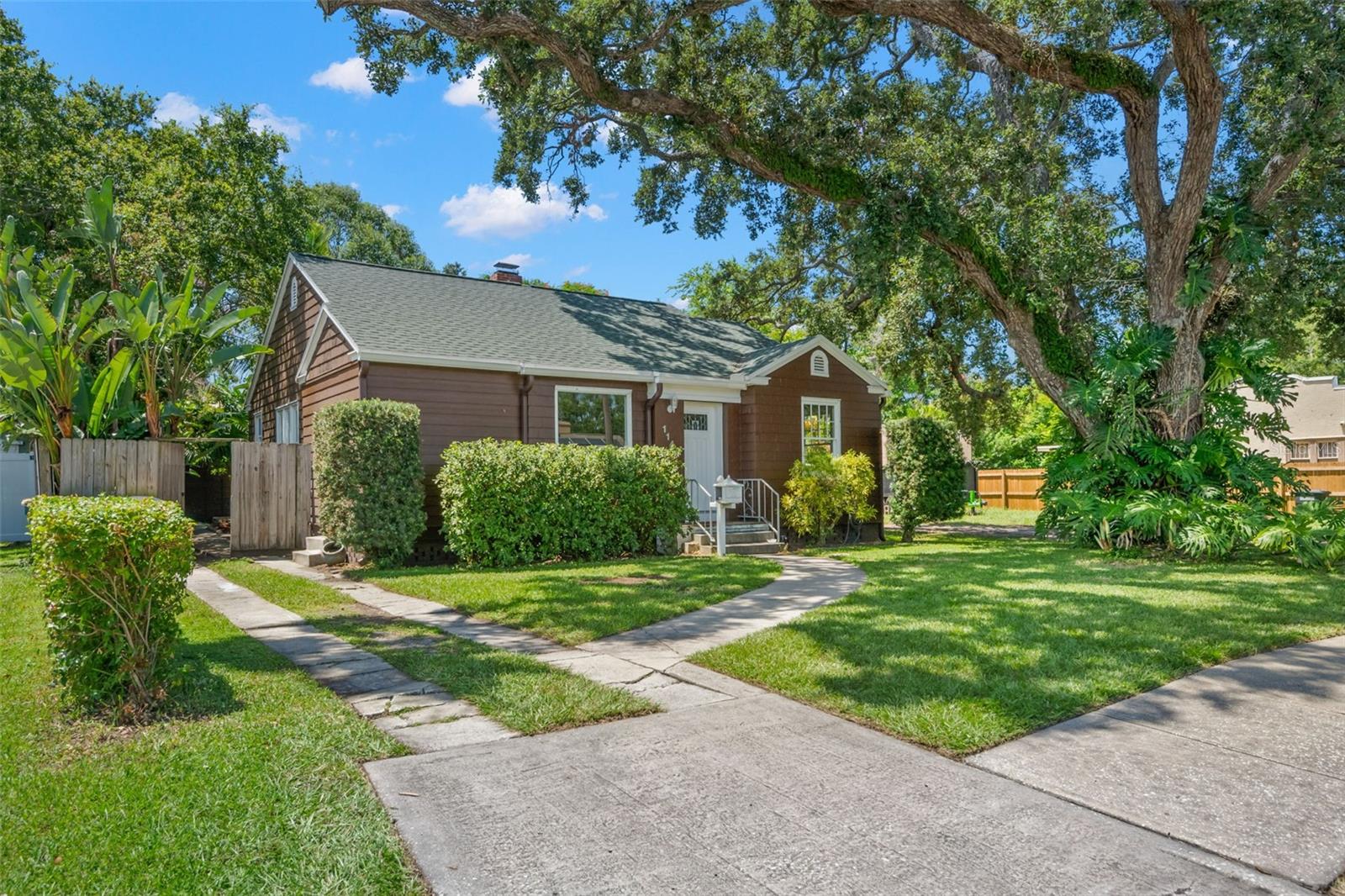 Charming Clearwater gem with stunning backyard oasis! Welcome home to this beautifully maintained 2-bedroom PLUS bonus PLUS den, 1.5-bath residence filled with charm, functionality, and fantastic bonus spaces—all nestled in a prime Clearwater location just minutes from downtown and area beaches! As you step through the front door, you're welcomed into a warm and inviting living room featuring a large picture window offering abundant natural light, wide baseboards and rich wood flooring throughout, a cozy brick-front fireplace with mantle—perfect for relaxing evenings. Additionally, there is a bonus storage closet off the living room that is also accessible in the hallway. To the left of the living room, you'll find a flex bonus room ideal for a home office, reading nook, or even a playroom. Adjacent is the formal dining room, which also boasts beautiful wood flooring and sunny windows that create an inviting space for meals and gatherings. The kitchen has a stylish blue/green-accent backsplash tile that adds a pop of personality. There is a double stainless steel sink, four-burner cooktop, dishwasher, and side-by-side refrigerator plus counter space for food prep and entertaining. Off the kitchen is a generously sized laundry room with washer and dryer and extra cabinetry and counter space—perfect for folding laundry or additional storage. With ample windows overlooking the backyard, this flex space offers bonus potential as an additional office or craft space. The primary bedroom features two large windows bringing in great light, a walk-in closet with built-in shelf, and a private half bath with additional cabinet and counter space. The second bedroom is light and bright with a closet with built-in shelving for optimal organization. The main full bath is located off the hallway and is updated with a step-in shower with sliding glass door, marble tile surround and decorative tile floor, plus a stylish vanity with drawer storage. The backyard is a true tropical oasis featuring a stunning brick-paved patio, ideal for outdoor dining and entertaining, lush landscaping and mature greenery and a soothing fountain that enhances the peaceful setting. There is an incredible oversized garage/storage shed with electricity, built-in shelving, and plenty of room for tools, bikes, or even a workshop. Located just minutes from downtown Clearwater, shopping, dining, parks, and world-famous beaches, this home offers the perfect combination of charm, functionality, and unbeatable location. Don’t miss out—schedule your private tour today and make this Clearwater gem your new home!