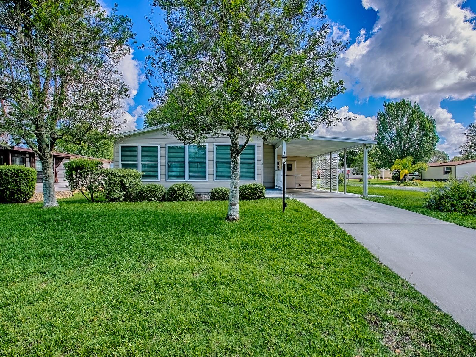 Owner motivated. Welcome to The Villages at The Village of Silver Lake! This 2-bedroom, 2-bath home offers formal living with separate dining room. An additional site-built sunroom runs across the full width of the home, creating a bright and welcoming space. The kitchen has Kraftmaid wood cabinetry and a solar tube to bring in the daylight. Skylights are in both bathrooms. Entire house is in luxury vinyl flooring, with the exception of the master bedroom, which has new berber carpet installed in 2023. Brand new roof in 2023, brand new HVAC in 2024, newer water heater. The primary suite includes a private en-suite. The second bedroom is just across the hall from the second bathroom. Additional features include an oversized golf cart garage with LG stacked front-loader washer and dryer, and ample space for a workshop. This is affordable Florida living in this golf course community, just minutes from shopping, dining, medical, and more. This property provides easy access to the Shay gate, is right across the highway from Spanish Springs Town Square, and is a short golf cart ride to Lake Sumter Landing Town Square. The property is only blocks away from the Silver Lake Golf Course, and is within a short golf cart ride to four other nearby golf courses. The house comes with a 13-month Home Warranty at no cost to the buyer.