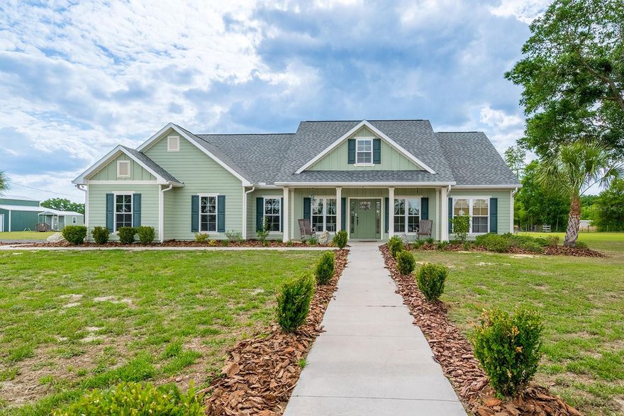 Discover the perfect blend of privacy, space, and functionality with this 3 bedroom, 2 bathroom home on 5 acres in Trenton. The property is tucked behind a gated entrance and is fully fenced, offering an ideal setting for a mini farm, homestead, or private country retreat in North Florida. Inside, the home features an open-concept floor plan designed for both everyday living and entertaining. The spacious kitchen offers abundant storage, making it both functional and inviting. The home is also equipped with a whole-house generator connected to a 1,000-gallon buried gas tank, providing reliable backup power and added peace of mind. The exterior of the property is well-equipped with improvements that add both value and versatility. There is a large pole barn that is perfect for storing equipment, RVs, or boats. In addition, the detached three-bay garage provides excellent space for vehicles, a workshop, or hobby use. Three additional storage sheds are located on the property, and all outbuildings have power already run to them. The property also includes two wells, offering added flexibility for agricultural use or irrigation. Located in Gilchrist County, this home provides a quiet rural lifestyle while still being conveniently close to nearby amenities. It is just minutes from downtown Trenton, where you will find local shops, restaurants, and schools. The property is also a short drive to Newberry and Gainesville, offering additional dining, shopping, and medical facilities. For outdoor enthusiasts, the location is ideal. The home is near the Suwannee River and the Santa Fe River, as well as several natural springs that are known for boating, fishing, kayaking, and other recreational activities. This property offers a rare opportunity to own a well-equipped home with acreage, outbuildings, and modern conveniences in a desirable North Florida location.