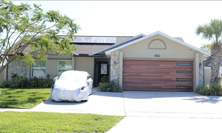 Discover this beautifully renovated 3-bedroom, 2-bathroom home featuring an oversized screened-in pool and an expansive patio complete with a covered outdoor bar — the perfect space for relaxing or entertaining year-round.

Inside, you'll find elegant porcelain tile flooring throughout, a fully updated kitchen with smart stainless steel appliances, modern cabinetry, and recessed lighting that creates a bright and inviting atmosphere. The spacious primary suite features customizable color-changing lighting, adding a unique touch of comfort and ambiance.

Both bathrooms have been tastefully remodeled with designer tile, contemporary vanities, upgraded showers, and modern fixtures. Additional upgrades include hurricane-impact windows throughout and a state-of-the-art solar panel system designed to maximize energy efficiency and help reduce utility costs.

Ideally located just minutes from major highways, top shopping destinations, restaurants, and entertainment, this move-in-ready home offers the perfect combination of style, comfort, and convenience.

Don't miss this incredible opportunity — schedule your private showing today!