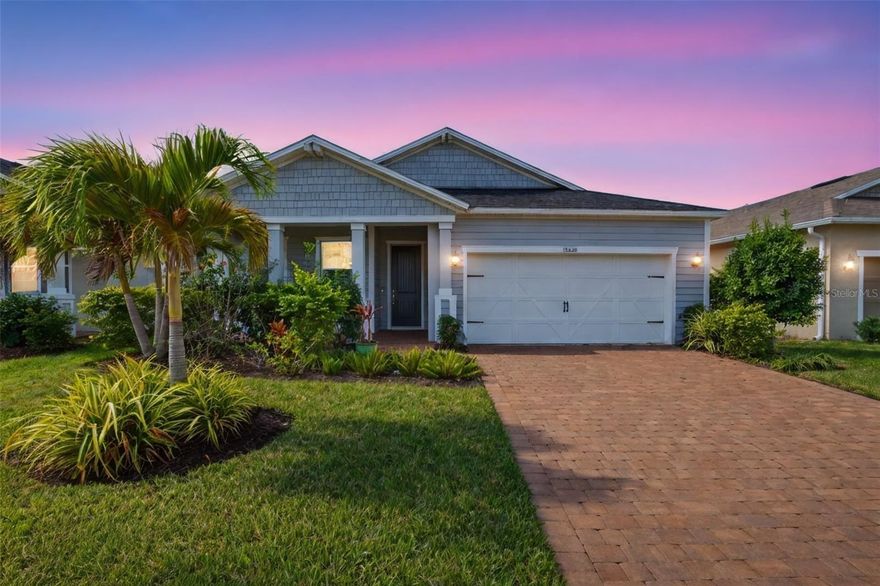 Welcome to Avaunce at Lakewood Ranch, a sought-after gated community known for its low HOA fees, no CDD fees, and a lifestyle that blends comfort with convenience. Perfectly positioned right down the road from the community pool, this beautifully upgraded residence offers 4 bedrooms, 3 bathrooms, and over 2,300 square feet of thoughtfully designed living space with peaceful water views.

From the moment you arrive, the home impresses with a wide paver driveway, manicured landscaping, and a charming front porch that sets the tone for what’s inside. Step through the front door into a bright, custom interior that feels straight out of a model, featuring luxury vinyl plank flooring, designer paint, upgraded lighting, and detailed woodwork throughout.

The main living area is both inviting and functional, centered around a stunning custom built-in entertainment feature that elevates the space. Large windows showcase serene lake views while filling the room with natural light, creating the perfect backdrop for everyday living and entertaining.

The kitchen is designed to impress with rich cabinetry, quartz countertops, a stylish tile backsplash, updated fixtures, and an oversized island ideal for gathering. A walk-in pantry with custom shelving adds both style and practicality, while the adjacent dining area flows seamlessly with the rest of the home.

The owner’s suite offers a private retreat with tray ceilings, custom wood detailing, and tranquil water views. The spa-like ensuite bathroom and professionally designed closet by Closets by Design complete the space. At the front of the home, a secondary bedroom with its own ensuite bath provides a flexible option for guests, multigenerational living, or a private office. Two additional bedrooms and a full bath are thoughtfully positioned for privacy, with custom closet systems continuing throughout.

Step outside to an expansive screened lanai offering nearly 640 square feet of outdoor living space. Finished with brick pavers, custom lighting, a mounted TV, and a private hot tub, this space is designed for year-round enjoyment overlooking the water.

Additional highlights include a whole-home water filtration system, epoxy-coated garage flooring, upgraded ceiling fans, and meticulous attention to detail throughout.

Residents of Avaunce enjoy access to a community pool, outdoor kitchen area, and activity center, all within a gated setting. Located just minutes from everyday conveniences, shopping, and dining, with close proximity to UTC Mall, Waterside Place, and some of Florida’s most beautiful Gulf Coast beaches. Zoned for A-rated schools, this home offers the ideal combination of location, design, and lifestyle.

A fresh opportunity to own a move-in ready, thoughtfully upgraded home in one of Lakewood Ranch’s most desirable communities.