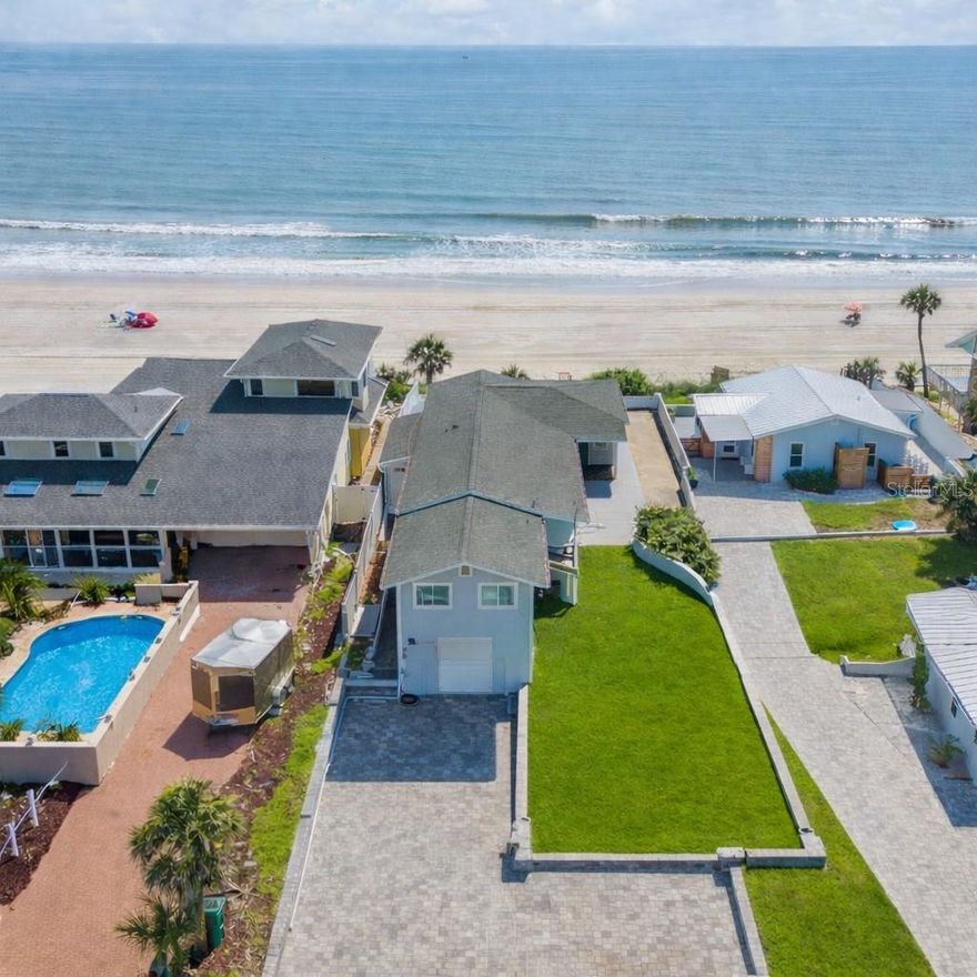 Located in Port Orange, just north of New Smyrna Beach and minutes from Daytona Beach, this direct oceanfront home sits along a quiet stretch of coastline near the iconic Ponce Inlet Lighthouse. Wake up to the sound of the surf and step directly onto a peaceful, no-drive beach from your private oceanfront retreat in Wilbur-by-the-Sea. This extensively renovated and fully furnished coastal residence delivers true direct oceanfront living with unobstructed Atlantic views, private beach access, and a turnkey lifestyle rarely available at this price point. Every major system and finish has been thoughtfully upgraded, including a new roof, impact windows, updated electrical and plumbing, Hardie board exterior siding, luxury vinyl plank flooring, quartz countertops, and beautifully renovated bathrooms. Sun-filled living and dining spaces frame sweeping ocean views, while the expansive outdoor areas, including an outdoor shower and private walkway, are designed for effortless beachfront living. The flexible lower level provides additional living space and an oversized guest bedroom, ideal for hosting family, guests, or creating a private retreat. Plantation shutters, custom finishes, and a beach-ready layout enhance both comfort and style. Sold fully furnished and truly move-in ready, this home allows you to enjoy the coast immediately with no delays.
Architectural concepts are available for a future primary suite expansion and additional bathroom, offering optional upside without urgency. A large private paver driveway for multiple cars, RV or boat, additional storage spaces on both levels and proximity to world-class beaches complete this incredible property