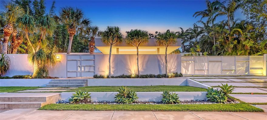 Perched on a hill above Hawthorne Street in one of Sarasota's most coveted West of Trail enclaves, this three-bedroom residence is a modern love letter to the Sarasota School of Architecture, designed by renowned architect Guy Peterson. Celebrated in books and design publications, the home is a modern marvel crafted from polished concrete, steel, impact-rated glass, and stacked Ocala block--earning numerous prestigious design awards. From the street, the walled and gated property presents clean lines built of enduring materials. The serene entry courtyard welcomes guests with mature landscaping and dramatic evening lightscapes. Once inside, the simplicity of the floorplan and material palette is a study in understated elegance, creating a harmonious sense of space and light. Birch paneling and stacked Ocala block adorn the walls, polished concrete floors reflect light throughout the space, and smooth level-5 drywall keeps the aesthetic crisp and contemporary. The layout of the home is masterfully executed: three bedroom suites line one side of the structure, while open-concept entertaining spaces span the opposite wing. At the rear, a central pool is framed by an open-air pavilion, creating a seamless indoor-outdoor flow that is ideal for hosting gatherings of any scale. At the heart of the home, the kitchen is outfitted with sleek custom cabinetry, stainless steel countertops, and premium appliances by Sub-Zero and Miele. A walnut built-in cabinet anchors the dining area, while the living room offers striking views of the pool on one side and a tranquil water feature on the other. The primary suite is privately situated away from the rest of the home with a generous custom walk-in closet and a light-filled ensuite bath that opens to the secluded side yard. Completing the home is a gated carport--a hallmark of the Sarasota School of Architecture style--as well as gorgeous, mature specimen plants curated by landscape architect David Young. This serene, sophisticated home offers a rare opportunity to own an architectural landmark in the heart of Sarasota, minutes from Southside Village, Morton’s Gourmet Market, Selby Gardens, and downtown.