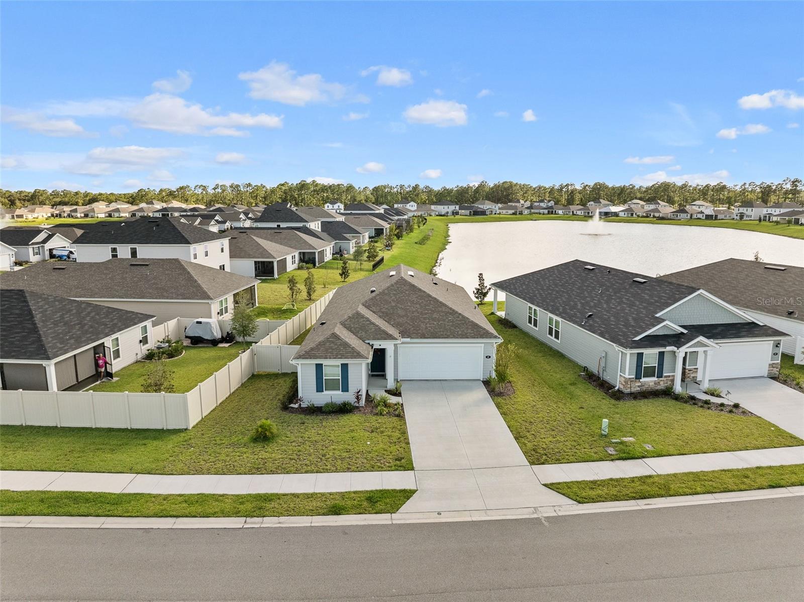 BETTER THAN NEW! Welcome to 65 Waverly Lane in Whiteview Village! Built in 2024 and thoughtfully upgraded, this 3-bedroom, 2-bath home offers 1,618 sq. ft. of stylish living in a gated community with a low HOA and access to a sparkling community pool. Inside, you’ll find a desirable split floor plan with vaulted ceilings and new tile flooring throughout all living areas, a modern kitchen with granite countertops, stainless steel appliances, cabinet lighting, and a cozy TV wall with an electric fireplace. The spacious primary suite features a walk-in closet, dual sinks, and a walk-in shower. A skylight fills the home with natural light, while upgraded ceiling fans and exterior lighting add comfort and charm. The enclosed screened lanai overlooks a serene pond, creating the perfect retreat for morning coffee or evening relaxation. Additional upgrades include a tankless water heater, natural gas connection, irrigation system, epoxy garage floor with attic storage, garage door opener, laundry tub, and a fully fenced yard. This move-in ready home combines the benefits of new construction with premium upgrades already in place—making it one of the best finds in Whiteview Village. Don’t miss this move-in ready gem—schedule your private showing today! Special financing with a lender credit to be used for closing costs, and or interest rate buy down. Borrower must qualify for our exclusive financing program.