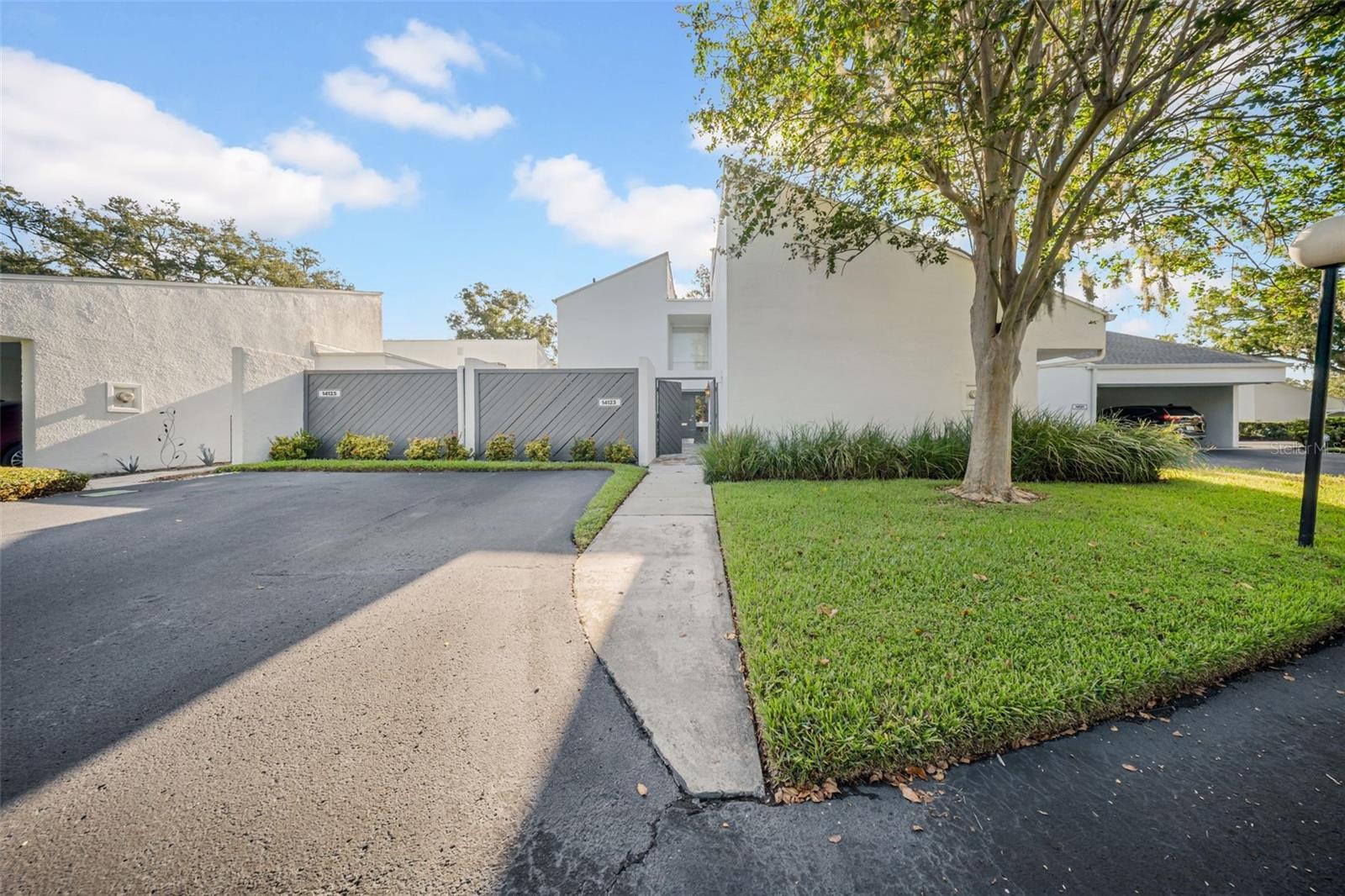 Welcome to this spacious 2-story condo townhouse in the highly desirable community of Carrollwood Village, offering 1,850 sq. ft. of living space and an exceptional blend of comfort and charm. Enjoy soaring 25-ft ceilings in the living and dining areas, a serene interior garden, a beautiful courtyard, and multiple outdoor retreats including a huge covered lanai, private deck, and second-floor balcony. The property backs up to the community pool, creating a relaxing backdrop right from your backyard, and features a NEW ROOF (2024) for peace of mind. The monthly condo fee covers exterior maintenance, grounds, gutters, roads, pool, reserves, roof, exterior painting, water, sewer, and exterior building insurance, allowing for low-maintenance living. Nestled on the Carrollwood Golf Course, Carrollwood Village also offers endless amenities—parks, gardens, playgrounds, tennis and basketball courts, walking and biking trails, and a vibrant cultural center. Conveniently located near Publix, Fresh Market, Whole Foods, shopping, dining, and entertainment, this home offers both lifestyle and location in one of Tampa’s most sought-after neighborhoods.