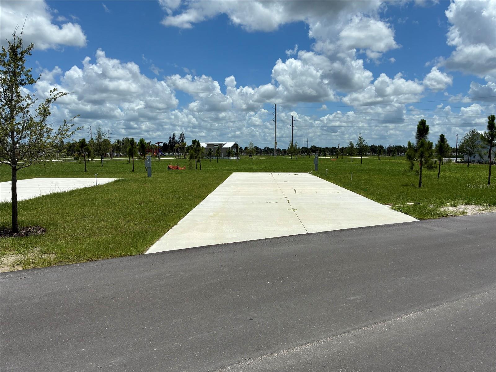 RV Pad in Premium Location in Luxurious RV Resort - Palm Breeze of Punta Gorda. New and exclusive amenity-rich RV resort with professional management. Site can generate income when you're not using it with the professional resort management service! Convenient to Dozens of White- Diamond Sand Florida Beaches. Fishing Piers on 3 Stocked Ponds. New Resort Style Pool and Hot Tub. Tiki Bar. On-Site Provisions Store, Golf Cart and Bicycle Rentals. Community Center with Shower Suites and Laundry Facilities. Fitness Center. Pickleball Courts, Bocce Ball, and Shuffle Board. Putting Green, Dog Park. Paved Roads. Site offers Water, Power, Sewer, and Community Wifi. This lot is very unique as it borders on open green space which gives it a feel of a much larger site size! No RV pad on that side!