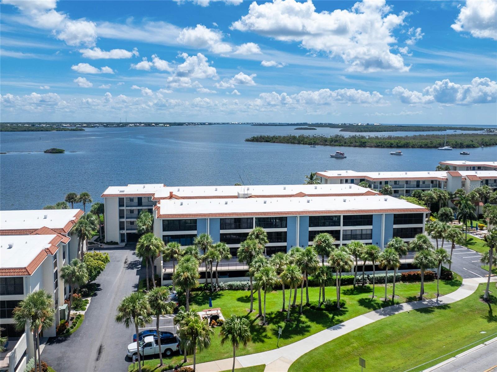 Beautiful 2 Bedroom/2 Bath Condo with Elevator on Sandpiper Key! Bring your suitcase - Being sold Turnkey with all new furniture. Totally remodeled with all new drywall and paint. Many upgrades including Brand New Hurricane Sliding Glass Doors, matching Quartz Countertops in kitchen and baths, matching Planking Tile and New Carpet throughout, Barn Doors, Pocket Closet Door, Privacy Shades, Recessed Lighting, Brushed Nickel Fans, Decorative Lights, Tiled Showers and Window Treatments. Brand New Air Conditioner System with Humidistat and Hot Water Tank. Open Kitchen has all new cabinets with brushed nickel handles, blue backsplash and Stainless Steel Appliances. Amenities include covered parking space, guest parking, bicycle/kayak and storage, two heat/cool pools, small fishing dock, gas grills, Clubhouse/Library/Social Activities and Rental Office. ASSOCIATION HAS PASSED THE STATE MANDATED MILESTONE STRUCTURAL INSPECTION WITH NO REPAIRS NEEDED AND REQUIRED RESERVES HAVE BEEN ESTABLISHED! This roadside condo in a waterfront community on Lemon Bay is only a 1/2 mile to beautiful Englewood Beach and nearby restaurants. Enjoy a walk or bike ride on the oversized sidewalk to the beach! Privately owned docks across the road are available to purchase or rent. Sandpiper Key is a special place and awaiting your arrival! Book your showing today!
