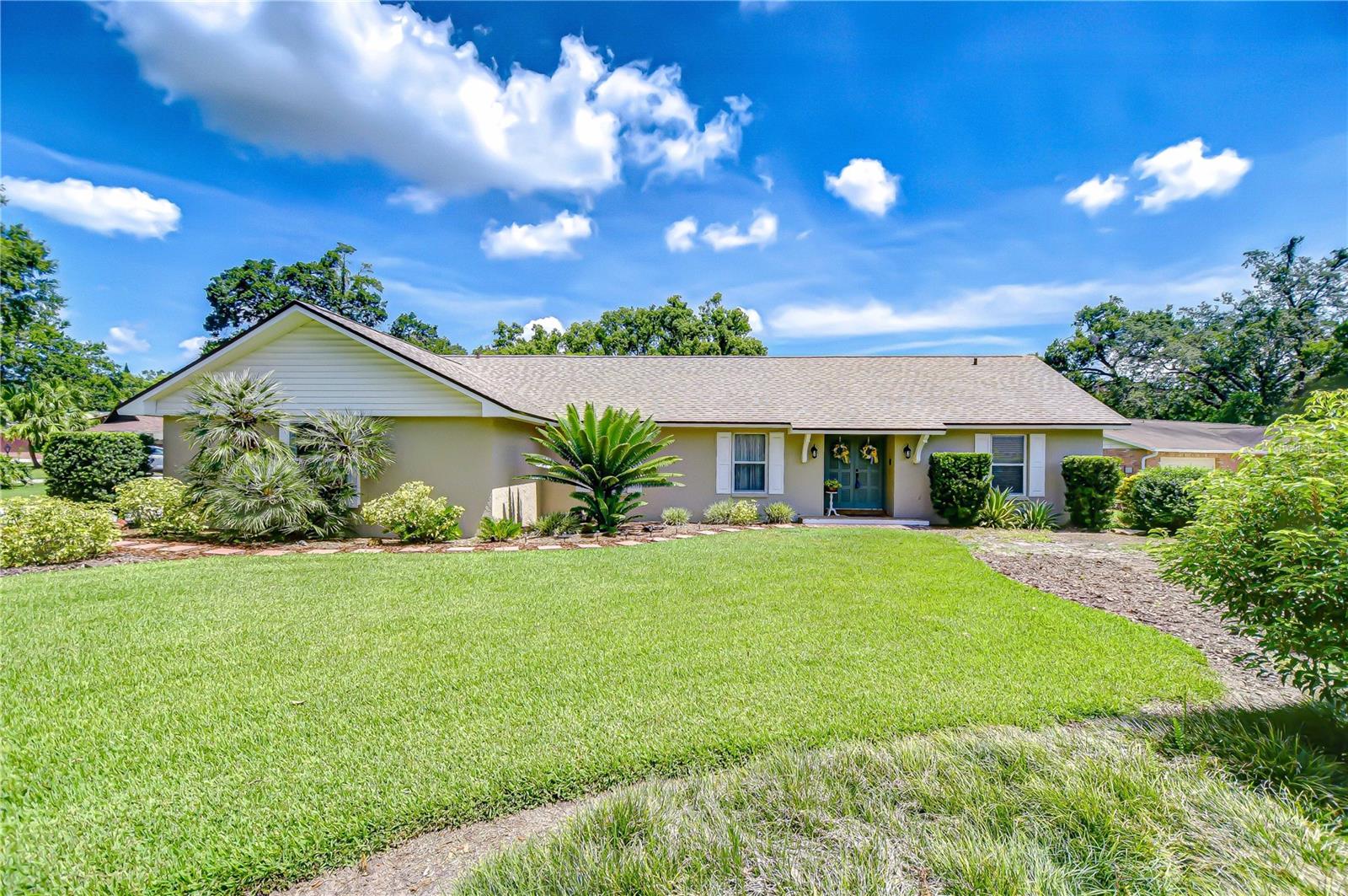 Welcome to this beautifully maintained home nestled in the established Parkwood Manor community—where there’s NO HOA or CDD! Positioned on a spacious nearly half-acre corner lot, this property offers the freedom to bring all your toys home. It features a two-car side-entry garage, extended carport, and a dedicated parking pad—perfect for a boat or small RV. Lush, tropical landscaping surrounds the home, creating privacy and great curb appeal. Step inside to a flexible layout with a formal living and dining area that’s ideal for entertaining or customizing to your family's needs. The remodeled kitchen is a dream for any home chef, offering generous prep space, ample storage, stainless steel appliances, and a breakfast bar. A sunny breakfast nook overlooks the backyard and flows into the inviting family room, which features wood-beamed ceilings, a stone wood-burning fireplace, and sliders leading to the screened back patio. The primary suite is a peaceful retreat with two walk-in closets and a private en-suite bath featuring dual vanities and a walk-in glass shower. Two additional bedrooms are located on the opposite side of the home and share a full bath, providing privacy and comfort for family or guests. Outside, the possibilities are endless—build your dream pool, start a garden, or simply enjoy the open space. The home also includes well irrigation, helping to keep water bills low. Located just minutes from I-75 and Highway 60, this home offers convenient access to nature escapes like Lithia Springs Park and Alafia River State Park, as well as a wide variety of nearby shopping, dining, and recreational options. This Parkwood Manor gem offers modern updates, thoughtful design, and the perfect layout for comfortable Florida living—inside and out. Copy and paste this link to tour the home virtually: my.matterport.com/show/?m=seC5KeVrnxH&mls=1