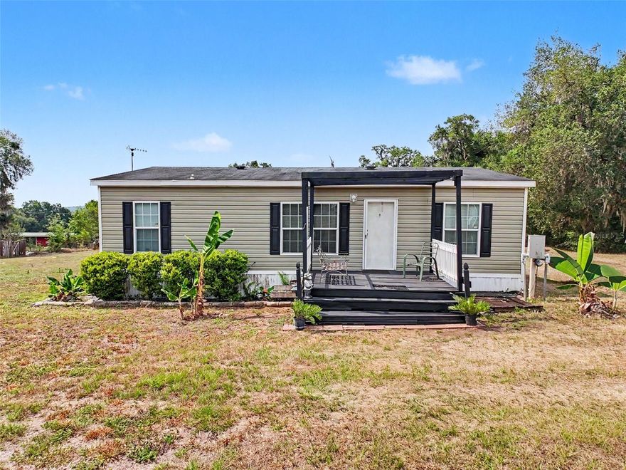 One or more photo(s) has been virtually staged. Looking for privacy, and the peace and quiet of the country? This 3 bedroom, 2 bath, with an additional room, 2018 manufactured 40x26 double wide sits on 3.30 acres zoned AG. NO HOA and NO CDD fees. There is a storage building, with it's own bathroom, a few other storage buildings and pole barn, which could use some renovation, or build a new barn and/or workshop to fit your needs. Property is mostly cleared with a wooded area in the back. Located in flood zone X, so flood insurance is not required. Privately maintained road with view of hayfields and woods. Feed the deer, which frequent the property, or enjoy other wildlife and all Mother Nature has to show. Lots of potential for this property and plenty of room for a barn, paddock, horse training ring, etc. A/C, roof, hotwater heater less than 8 years old. Bring the horses and farm animals, and live the country lifestyle away from the hectic city life, but still have easy access to Ocala, Orlando, Wesley Chapel, Tampa, St. Petersburg/Clearwater, etc., via S.R. 50, I-75, US 41 or US 301.
