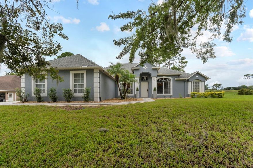This home is a unicorn home! It's located in a prime golf course community and features an oversized, elevated 1/2-acre lot with a side water view and a backyard overlooking the golf course. It's also fully updated and boasts a spacious and modern open-concept living space, integrating the kitchen, family room, and dining area - perfect for both entertaining and family living. You will fall in love with its dream backyard!  It's fenced and offers a large green space and a paved and screened area with a firepit, a jacuzzi, a complete summer kitchen, a seating area with TV, and an exterior shower - making it ideal for outdoor gatherings and relaxation. 

Step inside to discover new luxury vinyl flooring (2025), beautiful light fixtures, and a wood-burning fireplace enhanced with limestone.

The large kitchen island features a pantry with new glass doors, beautiful Black Galaxy granite countertops, stainless steel appliances, and a dining island.  

This residence features four generously-sized bedrooms, providing ample space for family and guests, along with two full bathrooms. One of the bathrooms has direct access to the back area, making it super convenient for hosting guests. If you have pets, this bathroom provides access to your pets through a pet door. The primary suite has private access to the back area, a walk-in closet with a custom shelving system, and a bathroom with a soaking tub and shower. 

The convenient laundry room includes cabinets, a washer and dryer, making daily chores effortless. 

The garage accommodates 3 cars and the large paved driveway (installed in 2024), your whole party of guests!

For added peace of mind, the roof was replaced in 2020. and the home's HVAC system in 2014, while the water heater was installed in 2015.

The property is equipped with solar panels generating an estimated production of 20194 kWh. It has 23 years of remaining $263.72 monthly payments (transferable to the buyer). The owners currently pay $35/month of power. An estimated savings of $300-$400/ month! 

The location couldn't be more perfect....Enjoy the benefits of living in a vibrant community near everything! Close to the Debary Sunrail Station and with easy access to I-4, connecting you to Orlando, Daytona Beach, and other major Florida destinations. Nature lovers will appreciate the nearby Blue Springs State Park and Gemini Springs Park, both within a 7-mile radius, offering outdoor activities and natural beauty.

Your dream home awaits—luxury, comfort, and outdoor paradise all in one! Contact us now to schedule your private tour and turn your dream into reality!