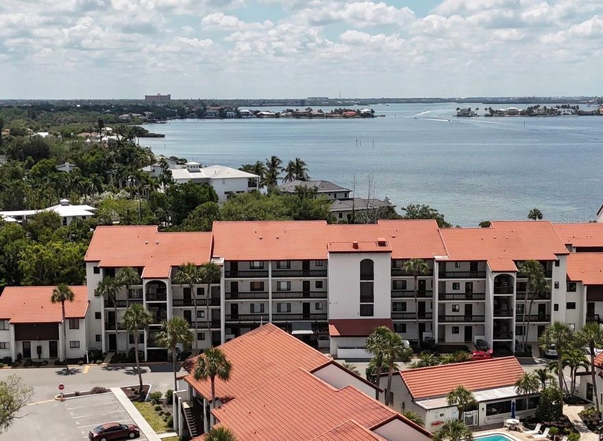 Experience the best of Sarasota living in this beautifully furnished 2-bedroom, 2-bath condominium in the sought-after community of Castel Del Mare.  Perfectly positioned at the south bridge to Siesta Key, this community offers a rare combination of waterfront ambiance and everyday convenience just minutes from world-famous Siesta Key Beach.  Inside, the open-concept floor plan is bright and inviting, with generous living and dining areas designed for comfort and ease.  Large sliding doors lead to a screened lanai and frame serene views of lush tropical landscaping, tennis courts and the intracoastal waterway. The updated kitchen features granite countertops, elegant wood cabinetry, tile flooring and a stylish back splash.  The spacious primary suite offers a peaceful retreat with access to the screened lanai, views of the Intracoastal Waterway, an en-suite bath and walk in closet with custom built-ins.  A comfortable guest bedroom and second full bath provide privacy for family and visitors.  Additional features include impact rated windows and sliders, assigned parking and tasteful furnishings.  Castel Del Mare is beloved for its exceptional amenities and unbeatable location.  Residents enjoy two heated pools, tennis and pickleball courts, shuffleboard, kayak storage, a fishing pier, bayside gazebo, clubhouse, grilling areas, bike storage and beautifully landscaped grounds.  This community offers direct access to the scenic waterfront boardwalk and is just a short stroll to restaurants, shops, marinas and boating options nearby.  Whether you are seeking a full-time residence, seasonal escape or investment opportunity, this condo offers outstanding flexibility, strong lifestyle appeal and the relaxed coastal atmosphere that makes Sarasota so desirable.  Enjoy sunrise walks, sunset views, dolphins along the bay, and the convenience of being close to everything Siesta Key has to offer.