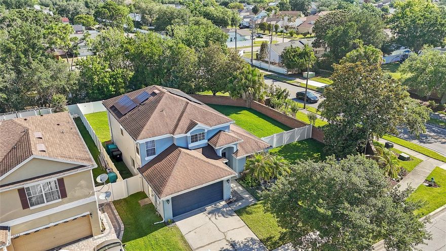 Welcome to the most premier opportunity in one of Orlando's well-established master-planned communities. This beautifully maintained 4-bedroom, 2.5-bath home sits on a premium oversized corner lot in Newport at Vista Lakes – one of the largest lots in the community – offering unmatched privacy, outdoor space, and curb appeal that discerning buyers know to look for. With 2,262 square feet of thoughtfully designed living space, this home strikes the perfect balance between functionality and visual appeal. Sunlight pours in, highlighting the open-to-below main living area that is equally suited for quiet evenings or effortless entertaining. The kitchen anchors the main floor, offering a seamless flow between the flex space, formal dining room, eat-in kitchen, and the glass sliders which lead out to the extended paver lanai. On the first level, you'll also find your primary en-suite, laundry room and powder bath, making every day living and functionality hassle-free. Upstairs, three spacious guest bedrooms offer a true retreat for family, friends, or for flexible use for an office, craft room, theater, and more. Newer appliances and core components provide peace of mind, including a 2025 water heater, 2018 HVAC, 2017 roof, and brand new stainless steel kitchen appliances. The home also features a whole-home water filtration system, and a whole-home solar system which is paid-off and offsetting the rising cost of energy! Step outside and the corner lot truly outshines the rest — an expansive yard with room to entertain, play, or imagine your future backyard oasis with ample space for a pool, playground, fire pit, and more. Vista Lakes offers stunning amenities including a resort-style pool, clubhouse, fitness center, tennis and pickleball courts, parks and playgrounds, scenic lake views, walking trails, and a vibrant community atmosphere, all within easy reach of top-rated schools, major employment corridors, the Orlando International Airport, Universal Studios, Walt Disney World, and more. This is the kind of home that doesn't come along twice — Contact us to schedule your private tour today!