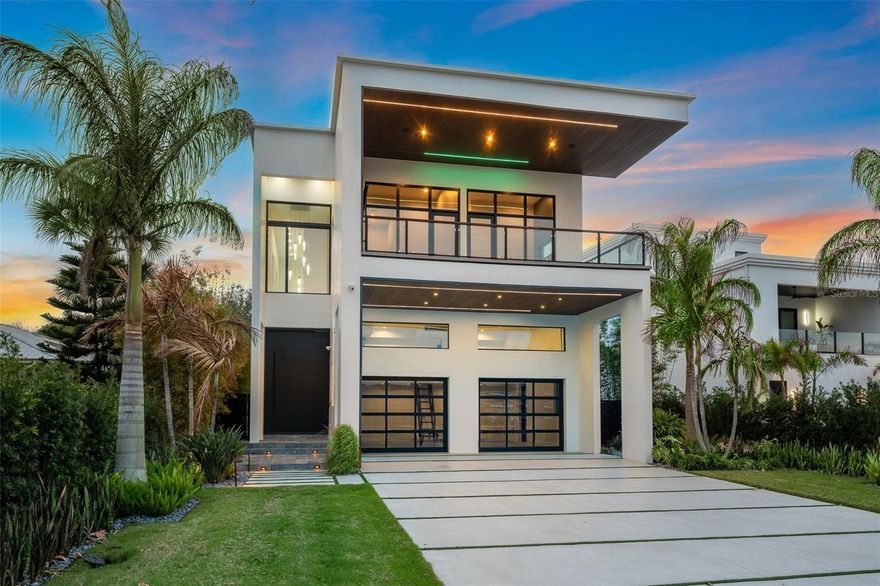 Direct Intracoastal luxury waterfront home in New Smyrna Beach, Florida, with deep water access, two blocks from the beach, and partial ocean views. This is coastal living at the highest level. Designed with a modern-inspired style, this new construction home offers a rare opportunity for both intercostal and beach living. 5-bedrooms, 5 full baths, 2 half baths, and over 5,500 square feet of modern design. Featuring clean architectural lines, soaring ceilings, and walls of glass capturing panoramic water views throughout. Situated on 51 feet of deep-water Intracoastal frontage, the property includes a seawall, private dock with water, electric, fish-cleaning station, and a boat slip accommodating a 40-foot yacht, ideal for dock-and-go boating, with future boat lift potential. The outdoor living space offers both relaxation and entertaining, with a fully automated Jandy saltwater infinity-edge pool and spa, tanning shelf, water features, fire elements, and a premium lighting package enhancing the waterfront setting day and night. The expansive waterfront patio and covered lanai create a resort-style environment, complemented by a fully equipped summer kitchen featuring a built-in gas grill, sink, ice maker, storage, and a 42-inch gas range. Inside, the open-concept main level offers seamless indoor-outdoor flow with three access points to the pool deck, connecting interior living spaces to the waterfront. The chef’s kitchen is outfitted with a premium Thermador appliance suite, including a 6-burner gas range with double ovens, refrigerator, wine fridge, freezer, and dishwasher, along with a Sharp microwave, farm sink, waterfall-edge quartz island, and sleek soft-close cabinetry with motorized upper cabinets. The first floor includes a private suite with a full bath and a walk-in closet, a hidden half bath, and laundry room. Additional features include wide-plank oak flooring, oversized baseboards, and a custom staircase with built-in lighting. A private elevator with automatic doors connects all three levels. Upstairs, on the second level you find the primary suite offering a private balcony overlooking the Intracoastal, a spa-style bath with walk-in shower, Hilo sauna, and steam room, along with a custom-built closet with LED lighting. Direct balcony access from both the bedroom and bath enhances the indoor-outdoor connection. The second level also includes a second laundry room and three additional bedrooms with ensuite or adjacent baths, including two with a shared balcony. The third floor features a spacious observatory-style loft designed for entertaining, complete with a wet bar, sink, wine fridge, and half bath. This level opens to both a waterfront balcony and a rear-facing balcony with ocean views, creating a unique elevated entertaining space with panoramic vistas and strong indoor-outdoor flow. Additional highlights include Crestron lighting automation, a two-car garage with high ceilings and epoxy flooring with potential for lifts, and an expansive driveway accommodating multiple vehicles. Positioned between the Intracoastal Waterway and the Atlantic Ocean, the property offers a rare boat-to-beach lifestyle just minutes from Flagler Avenue, top restaurants, marinas, and a 2-minute walk to the beach. New construction Intracoastal homes with deep water, private dockage, modern architecture, and ocean views are rare. This is a standout opportunity in New Smyrna Beach.