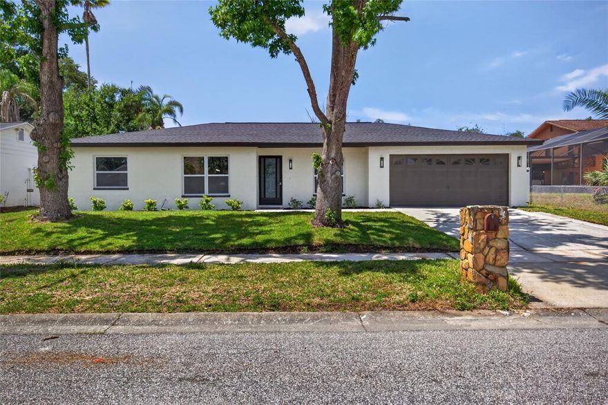 Welcome to the highly sought-after Northdale area! This beautifully designed 3-bedroom, 2-bath home offers 2,445 square feet of versatile living space, complete with a spacious office and bonus room perfect for working from home, entertaining, or additional flex space. Step inside and immediately notice the modern finishes throughout, including elegant trim work around windows and doors, decorative wainscoting in the common areas, light contemporary flooring, and modern lighting and plumbing fixtures. The stunning kitchen showcases contemporary shaker cabinetry, white quartz countertops, a large entertaining island, stainless steel appliances, and a stylish wine bar area ready for hosting guests. Both bathrooms showcase contemporary tile designs, modern vanities, and white quartz countertops. The spacious primary bathroom features an oversized vanity with exceptional counter space and storage. Recent big-ticket items include a brand-new 2026 roof and brand-new 2026 AC system for peace of mind. Additional features include a spacious 2-car garage, PVC-fenced backyard, and a covered screened porch perfect for enjoying Florida afternoons year-round. Located in the heart of Northdale, this home offers convenient access to Dale Mabry Highway with endless shopping, dining, and entertainment options nearby. Easy access to I-275 provides quick access to downtown Tampa, while the Veterans Expressway makes commuting to St. Pete or north Tampa a breeze. Buyer to verify public records for square footage, permitting, and home details.
