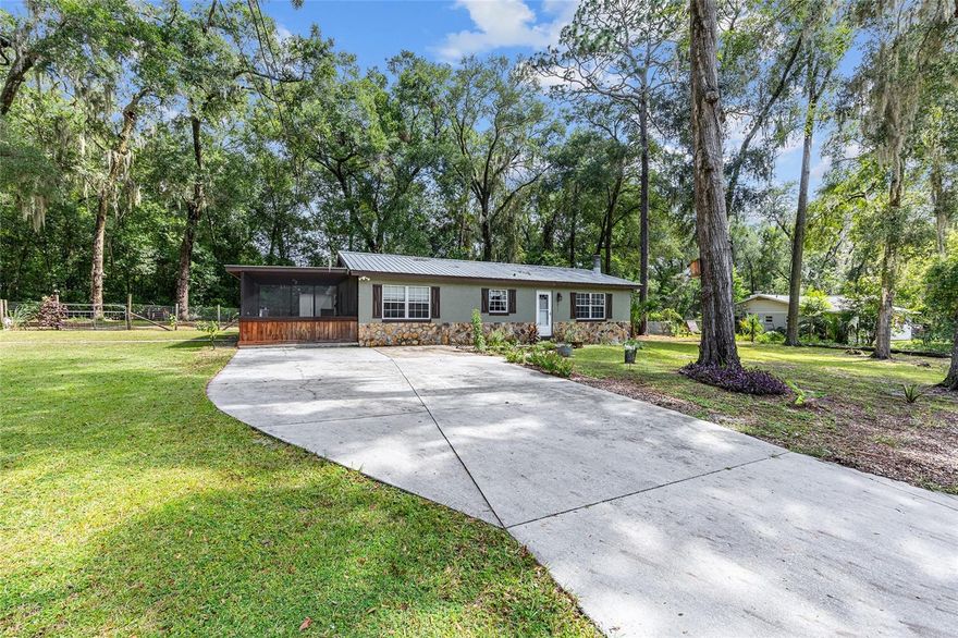 One or more photo(s) has been virtually staged. Lovely 3/2 home with metal roof located in oversized lot.  Property includes large workshop building.   Enjoy living on a dead end rd. where privacy and proximity to downtown Ocala. Large Yard has plenty of room for toys and entertainment.
