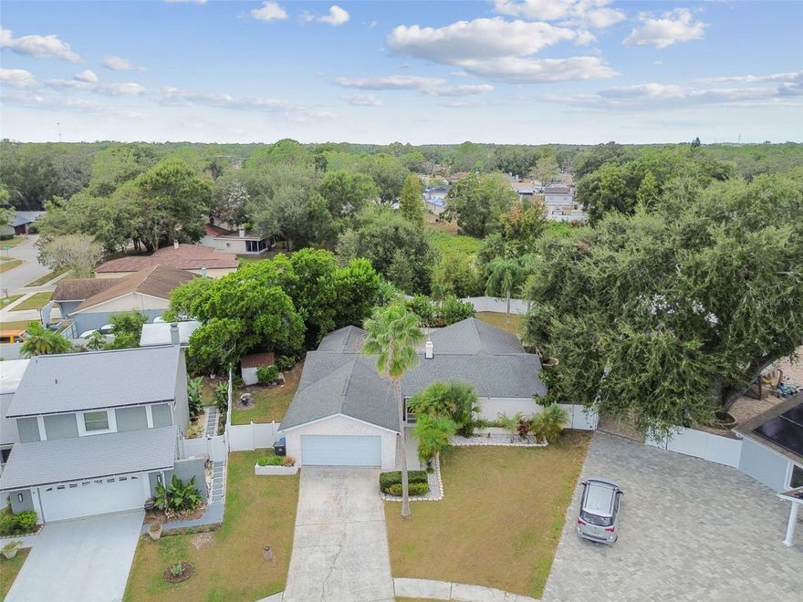 This 4 /2/2 pool home has the perfect split floor plan offering so many options! -With a flexible layout that allows you to reconfigure spaces to suit your needs. Create multiple living areas, a formal dining space, or even a dedicated home office. This inviting home is warm, sunny and bright and has a large addition that bathes the home in natural light and seamlessly connects to your outdoor retreat!!!
The fenced in backyard oasis is the true gem of this home, with an Outdoor Tiki Retreat beautifully paved with historic bricks, this one-of-a-kind space is ideal for grilling and retreating from the Florida sun. A charming tiny rustic cottage doubles as a changing room or storage for poolside essentials, while an outdoor shower, lush tropical landscape and no rear neighbors bring a true resort feel right to your doorstep.
Inside, the primary suite offers a private en-suite bath.  The split bedroom layout includes an adjoining room to the primary---- Ideal as a nursery, oversized walk-in wardrobe, or easily converted into a private fourth bedroom. Two additional bedrooms and a full bath are located on the opposite side of the home, and all four bedrooms are spacious enough to accommodate a king-sized bed. 
Located in a friendly Carrollwood neighborhood with no HOA, no CDD, and an X flood zone, this home is also zoned for some of Hillsborough County's top-rated schools: Northwest Elementary, Smith Middle, and Sickles High.
Don't miss the chance to make this one-of-a-kind pool home your own offering flexibility, character, and a backyard retreat you'll never want to leave!