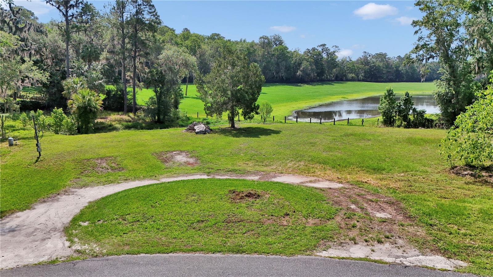 MUST SEE and READY TO BUILD, LAKEFRONT LOT, a RARE FIND in Ocala. Create your own private retreat in the gated community of Oak Creek Caverns, where luxury and serenity go hand in hand. This exceptional 1+ acre lot with retaining wall is located on a cul-de-sac. The views from your new backyard would look over the stocked lake and out to the rolling hills of a horse farm and are breathtaking. The prep work is done for you to place a below ground septic. Lot has an existing power pole and irrigation well .Engineering study has been done and, clay removed and replaced with clean fill and septic sand. This community offers privacy while being close to great schools, shopping, hospitals/medical care, Heath Brook Plaza, and is about 9.5 miles to the World Equestrian Center. HOA requires 2500 sq ft living space for a single story and 1500 sq ft living space for the 1st floor of a 2 story home. Measurements are estimated. Contact HOA to verify. Irrigation well is grandfathered in. Make your mark here and let your vision for your beautiful lakeside santcuary come to life.