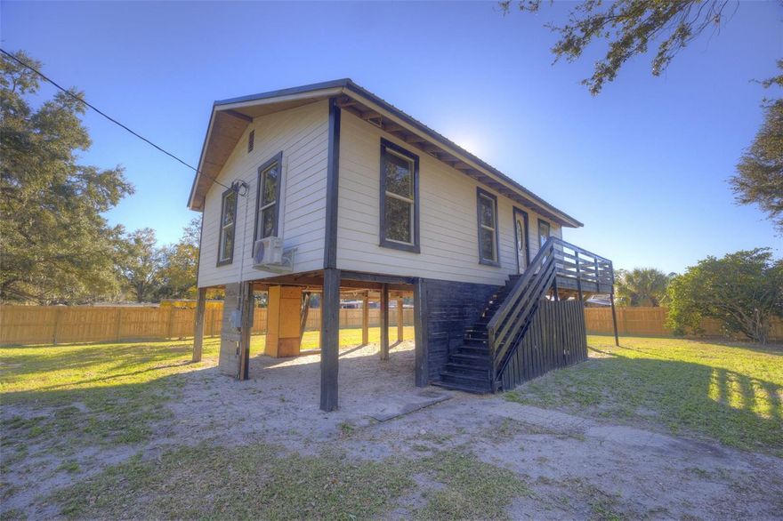 Welcome to this beautifully renovated home, thoughtfully redesigned for modern living and perfectly positioned on just over ? of an acre with picturesque views of a strawberry field across the street. Elevated on stilts, the home offers both charm and peace of mind, along with a sense of privacy and open space rarely found at this price point.

Inside, you’ll find a smart and functional floor plan with two bedrooms and a well-balanced layout. The spacious primary bedroom is tucked away for added privacy, while the secondary bedroom sits on the opposite side of the home—ideal for guests, roommates, or a home office setup. A centrally located bathroom and hallway connect the living spaces seamlessly.

The open living room flows into the dining area and kitchen, creating a comfortable space for everyday living and entertaining. Natural light fills the home, enhancing the fresh updates completed by the seller throughout—making this property truly move-in ready.

Outside, the expansive lot offers endless possibilities for outdoor living, gardening, storage, or future improvements, all while enjoying serene views and a peaceful setting.

If you’re looking for a fully renovated home with land, character, and a unique setting, this one is a must-see.