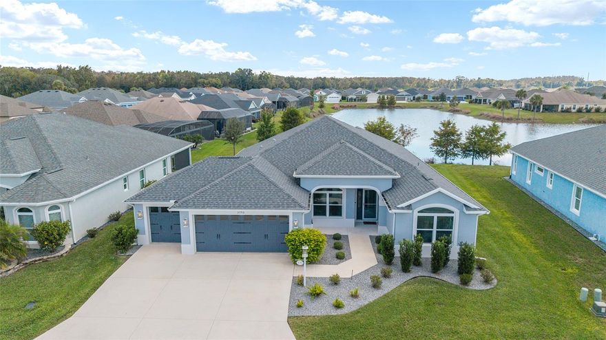 Welcome to your DREAM HOME situated in the highly coveted village of Hammock at Fenney. Highlighted by its natural setting, Hammock at Fenney boasts a resort-style zero-entry family pool, the popular Fenney Grill restaurant, two executive golf courses, a sports pool, pickleball courts and numerous other amenities. 
Enter this bright and beautiful home and be captivated by the gorgeous WATER AND NATURE VIEWS that greet you. The OPEN-CONCEPT FLOOR PLAN, HIGH CEILINGS and SLEEK AND MODERN DESIGN create a seamless flow throughout the living spaces. The expansive living and dining areas are filled with natural light. STACKING SLIDING DOORS lead to the STRETCHED LANAI, where the serene waterfront setting provides the ideal backdrop for unwinding or entertaining. 
The kitchen is a showstopper, adorned with LUXURIOUS QUARTZ COUNTERTOPS, TILE BACKSPLASH, 42-INCH CABINETRY, and sleek STAINLESS-STEEL APPLIANCES. There is plenty of counter and storage space, including roll-out drawers in the cabinets. 
Beautiful TILE PLANK FLOORING (no carpet) and UPGRADED LIGHT FIXTURES add warmth and sophistication to the space. 
The EXPANSIVE PRIMARY SUITE offers a private sanctuary, thoughtfully separated from the guest bedrooms. It boasts DUAL CUSTOM WALK-IN CLOSETS and a GENEROUS PICTURE WINDOW that beautifully showcases tranquil water views. The en-suite bath continues the theme of luxury with QUARTZ COUNTERTOPS and a spacious ROMAN SHOWER. 
Both guest bedrooms are nicely-sized with CUSTOM-DESIGNED CLOSETS. The laundry room has ample cabinet space and a utility sink. 
The EXPANDED TWO CAR, PLUS GOLF CAR GARAGE, complete with a durable EPOXY-COATED FLOOR, adds versatility and convenience.
Every detail of this exceptional home has been carefully curated for a lifestyle of comfort and a deep connection to nature. Shopping, dining, recreation and golf are all nearby. Location is conveniently situated between Brownwood Paddock Square and the upcoming Eastport, with both just minutes away. 
This MOVE-IN READY home is perfectly positioned in one of The Villages' most beautiful neighborhoods and is sure to be a favorite oasis for your family for years to come.