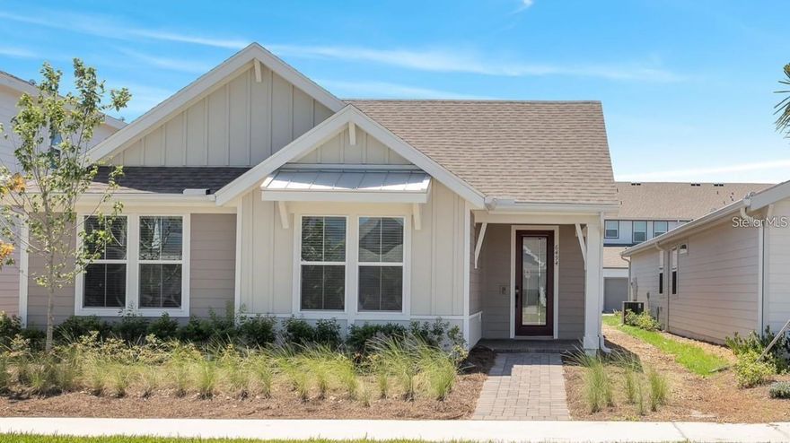 Beautifully upgraded home located in the community of Sunbridge. Situated in Weslyn Park, this elegant residence offers 3 bedrooms, 2 bathrooms, and a thoughtfully designed open-concept layout perfect for modern living. The gourmet kitchen is a true showstopper, featuring premium appliances—including the latest Samsung Bespoke refrigerator—a spacious island with marbleized quartz countertops, cabinetry, a wooden canopy range hood, and contemporary pendant lighting. The primary suite is designed for relaxation, boasting a tray ceiling, accent wall, custom walk-in closet, and a spa-inspired bathroom complete with dual-sink quartz vanity and a glass-enclosed walk-in shower. The secondary bathroom also features designer finishes and quartz countertops. The gathering room impresses with a tray ceiling, stylish accent walls, and colors that seamlessly complement the kitchen and appliances. Throughout the home, you’ll find luxury wood-look porcelain tile flooring (no carpet), treated with a special coating to preserve its rich finish. All kitchen and bathroom cabinets feature soft-close technology. Enjoy year-round comfort with modern ceiling fans in every room, including the covered lanai, all smartphone-controlled for convenience. The two-car garage offers epoxy flooring and an EV charger. The spacious laundry room is equipped with custom cabinetry, a utility sink, and Samsung Bespoke washer and dryer. This energy-efficient home includes paid-off Tesla solar panels and is pre-plumbed for a water softening system. Located just steps from community amenities such as a resort-style pool, walking trails, playground, and dog park, as well as the upcoming mixed-use Marina District—soon to feature waterfront dining, shops, and water activities. Additional highlights include 1 Gig high-speed internet provided by the HOA, a new school and a Publix shopping center just 5 minutes away. Ideally located near Lake Nona, FL-417, and Orlando International Airport, this home offers luxury, convenience, and lifestyle. Don’t wait to build—move right in and start enjoying everything in Sunbridge. Schedule your private showing today!