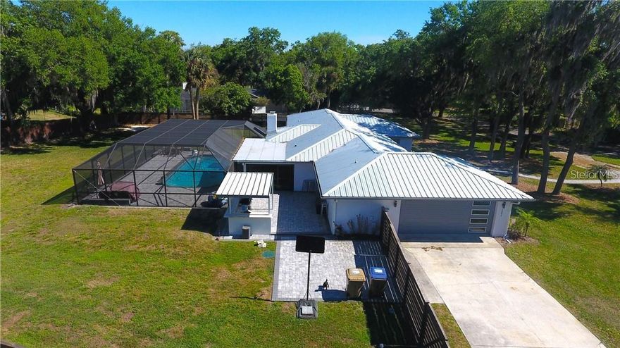 Under contract-accepting backup offers. Spacious and Modern home on a .77 ACRE LOT!!! This home has it all. Beautiful 5 bedroom 2.5 bath pool home located in the very desirable 34744 zip code. This home is completely renovated with modern touches throughout. Beautiful inside and out. Screened in pool, pool heater, and remote controlled cage lights around the pool that change colors. Pavers, summer kitchen, outdoor bath, 2025 whole house water treatment system, metal roof, 9in insulation in the roof and granite countertops. Two septic tanks that were replaced last year. A 2023 12x10 Tuff shed with a 7-year warranty. An AC coil purification system that prevents bacteria growth.  Make this your new home for 2026!!