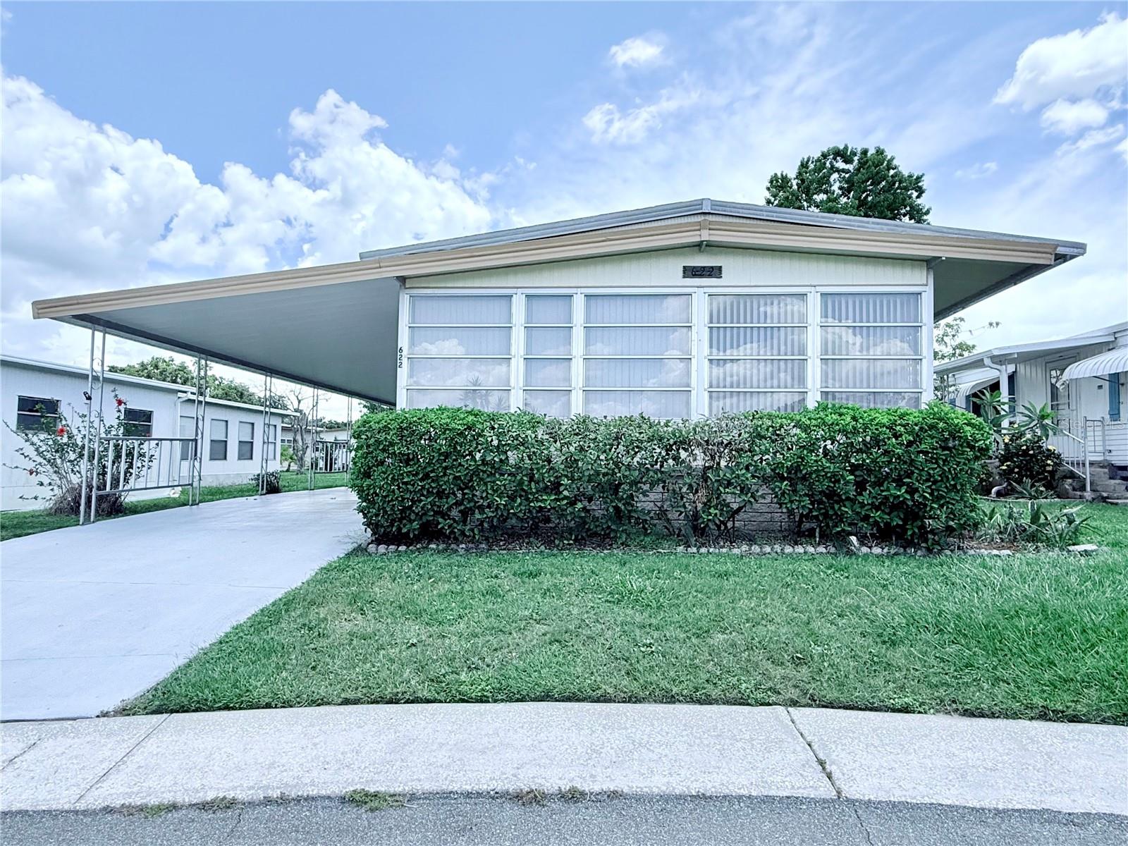 Welcome to 622 Elizabeth Lane in the highly desirable Lakeside Hills Estates—a 55+ community offering an active lifestyle and excellent amenities! This charming 2-bedroom, 2-bath home is located in one of North Lakeland’s most sought-after neighborhoods, where residents enjoy a low monthly HOA of just $285 that includes cable, internet, water, grounds maintenance, and access to community amenities. NO LOT RENT! You own the land your home sits on. Please note: this is a no-rent community.
This well-maintained home features a metal roof installed approximately 7 years ago and just pressure-washed and resealed, partial plumb repiping, and a newer A/C system under warranty until 2028. The exterior was freshly painted just 5 years ago, giving the home great curb appeal. Inside, you’ll find built-in cabinetry, indoor laundry conveniently located in the kitchen, and a layout perfect for comfortable living.
The large primary suite offers a walk-in closet plus an additional secondary closet, and a tub/shower combo in the ensuite bath. The guest bathroom features a walk-in shower with built-in cabinetry and new high-profile toilet. Flooring includes cozy carpet in the bedrooms and main living areas, with linoleum in the kitchen & tile in the hallway for easy maintenance.
The home is partially & tastefully furnished and includes a washer and dryer for your convenience. Please note: functionality of the dishwasher is unknown as it has not been used during ownership. A recent 4-point inspection is available, providing peace of mind for potential buyers. Note: this is a CASH ONLY sale due to the year of the home.
Don’t miss your chance to join this welcoming and amenity-rich community. Schedule your private tour today!