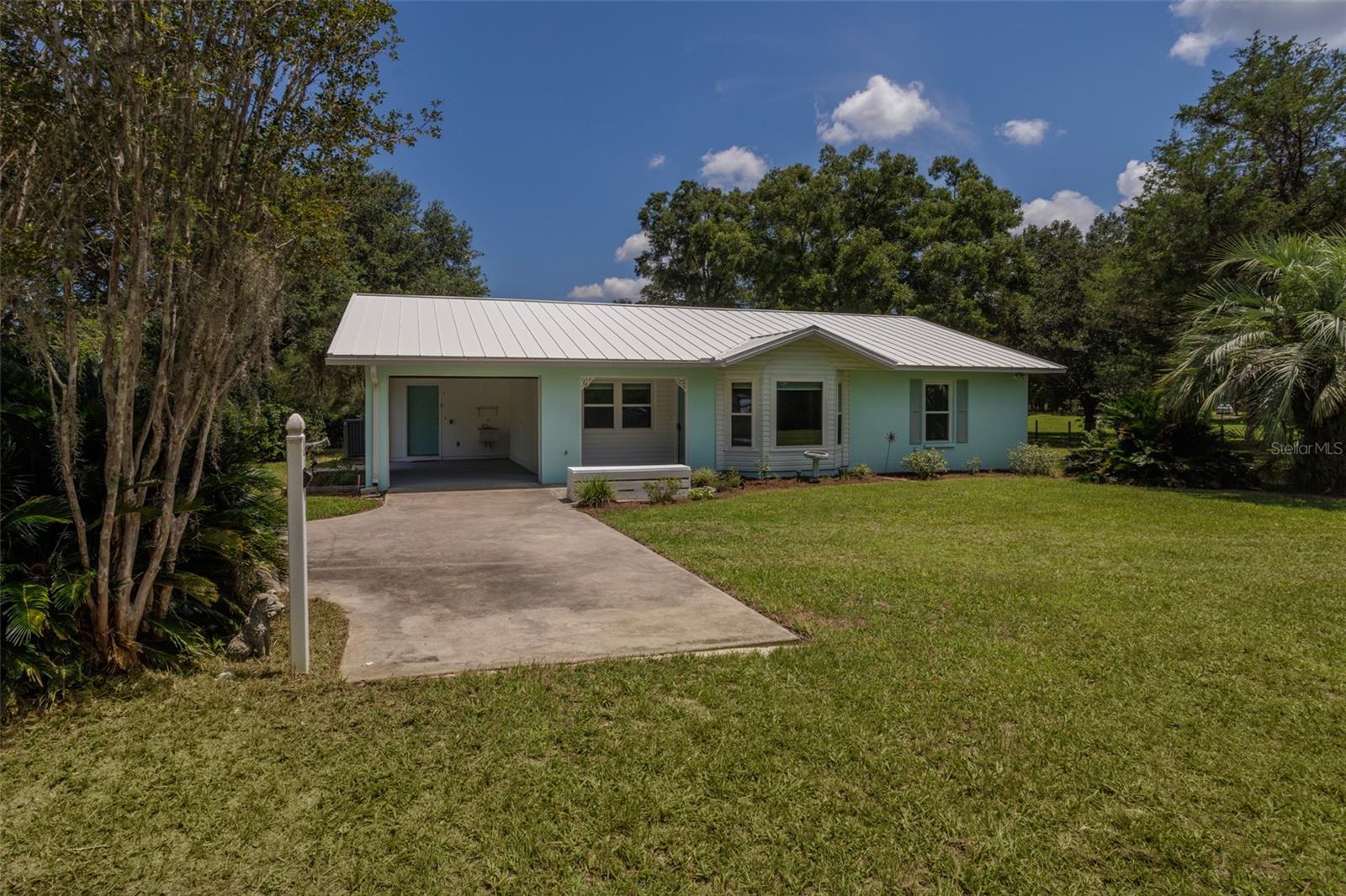 Discover peaceful country living in this thoughtfully updated 2-bedroom, 2-bathroom home offering 1,548 sq ft of comfortable living space. Nestled on a generous 2.28-acre lot, this concrete block home—complete with a metal roof—seamlessly combines durability with small-town charm. This home offers it all: nature, land, screened in porch, and a shed for storage all fenced in. Inside you'll find tile and wood throughout, plenty of natural light, and a spacious floor plan including a laundry room. You don't want to miss this opportunity to make this home yours!