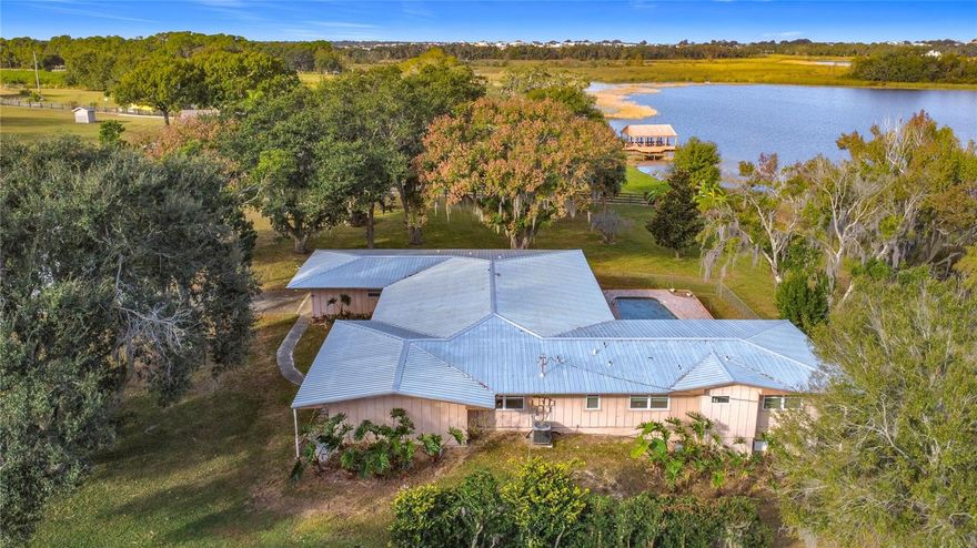 Unique and charming lakefront home offering just over 3,500 sq. ft. of living space, featuring large, spacious rooms throughout, beautiful wood floors, and a newer metal roof (2022). Enjoy a refreshing pool and an expansive 15' x 42' Florida room, all situated on just over an acre of serene, picturesque property. Inside, the spacious kitchen boasts solid wood cabinets, providing the perfect foundation for your personal updates and design vision. This home is truly ready to be brought back to its glory days, full of character, potential, and timeless charm. Located on Lake Lucy, this home is part of a vibrant and scenic Chain of Lakes in northern Clermont, including Lake Lucy, Lake Emma, Cherry Lake, and the Palatlakaha River Waterway. Ideal for fishing, boating, skiing, air boating, and endless outdoor exploration, this chain offers the ultimate Florida lakefront lifestyle. Great location too! Only 10–15 minutes to the FL Turnpike, 45 minutes to downtown Orlando and the theme parks, and just 20 minutes to Historic Downtown Clermont, known for its charming historic homes, unique shops, restaurants, breweries, and lively nightlife. You're also only 20 minutes south of The Villages, offering even more conveniences and entertainment options. Are you ready to embrace the lakefront lifestyle in this one-of-a-kind home? Start your adventures by building your own boat dock and enjoy everything this beautiful setting has to offer!