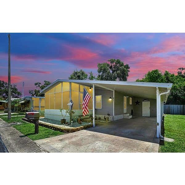One or more photo(s) has been virtually staged. Welcome to your new home in one of St. Pete’s most peaceful and well-maintained 55+ communities! This charming and move-in ready mobile home features a spacious kitchen with a center island—perfect for cooking and entertaining. The home also offers a spacious master bedroom with a walk-in closet and en suite bathroom, providing a private and comfortable retreat. Enjoy the Florida breeze from your screened-in front porch, or take advantage of the large storage area conveniently located just off the carport. A new A/C system was installed in 2021, ensuring comfort year-round. The community offers a clubhouse, swimming pool, and recreational facilities, all included in a low monthly HOA of just $245—which also covers water, sewer, trash, and more. Located close to shopping, dining, beautiful beaches, and everything St. Petersburg has to offer—this home blends comfort, convenience, and value. Don’t miss your chance to own a slice of paradise in this friendly and active 55+ neighborhood!