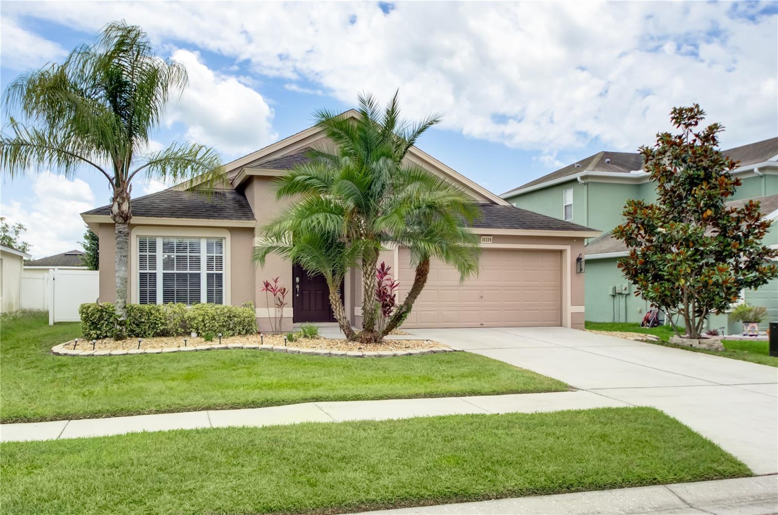 Enjoy living in this beautifully maintained 3bed/2bath/2car garage home in the highly sought after neighborhood of Palm Cove!! As you enter the home you'll notice the natural light and a large open floor plan with laminate floors throughout. The kitchen features granite countertops, wood cabinets, backsplash and tile flooring (Appliances pictured are older-kitchen now has stainless fridge/dishwasher). Through double doors you will enter the spacious master bedroom with a large bathroom including dual vanities, granite countertops, soaking tub and walk in shower. Then a nice large open family room with three panel sliding glass doors leading to the beautiful fenced in yard. The beautifully landscaped yard features a fence, fire pit, and a patio tiled area covered by a vinyl gazebo, just perfect for entertaining. The Palm Cove neighborhood amenities include a pool, walking trail, dog parks and playgrounds. Located close to I75, shopping, hospitals and schools.