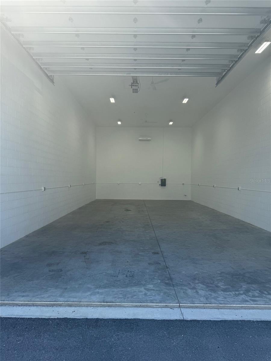 Large BRAND NEW 24x52.5 foot storage unit conveniently located in Punta Gorda near the intersection of US 41 and Acline Road. ** UNIT #9 ** is located in building C in the just completed Elite Indoor Vehicle Storage. There are 8 buildings total in this complex. This new fenced facility with security gate offers complete safety and storage of RVs, boat, cars and other valuable toys. Property features: fenced and secured, gated access, fire alarm system, monitored security system, digital surveillance in multiple locations, pump out station, water and wash area, security lighting, two ADA restrooms. There is an 80 foot apron that offers room to maneuver the largest RV. Over head doors are 12x14 feet and insulated. There are separately metered individual 100 amp electrical panels, 50 amp RV receptacles and 8 foot surface mounted lights. Association dues are $83/ month and include building insurance, common utilities, landscaping, maintenance and reserves.