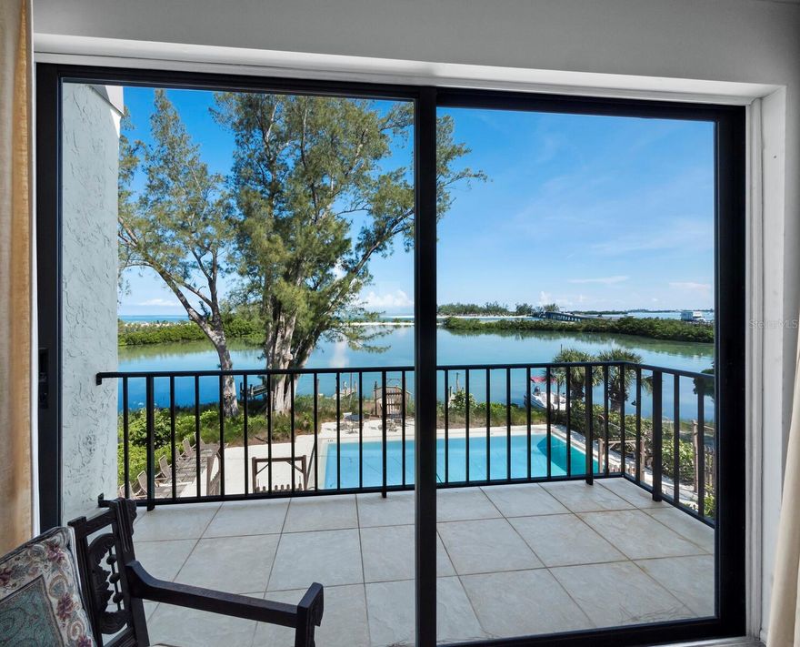 This rare offering is all about the one-of-a-kind BREATHTAKING VIEWS overlooking multiple waterways across Greer island, towards the Intracoastal and out to the gorgeous Gulf of Mexico sunsets! Situated on the quiet north end of Longboat Key in a small, waterfront, boutique midrise building containing only 9 residences: this is island living at its best! It features two bedrooms and 2 and a half baths plus a bonus ground floor air conditioned room and a workshop. Take the steps up to your first living level and enjoy a galley kitchen open to the large great room with sliders to one of 2 outdoor balconies above the ground level, poolside covered porch. On this level is also a half bath. Take the steps up to the second level and the views become even more astounding through the sliders from the Primary ensuite bedroom! Here you will also find the 2nd bedroom and the second bath. Besides the sparkling waterside pool, this small and friendly community has 3 small docks available that allow for easy water access with your kayak, paddleboard or small boat. And don’t forget it has its own clay tennis court as well. One of the nicest and widest beaches on Longboat Key is located just down the street and it wraps all the way around Greer island where you can stand and admire your condo across the waterway from your walk! Multiple restaurants and shopping destinations are within a bike ride or short walk away and the cultural epicenter of downtown Sarasota and Bradenton are just off island when you choose to leave. This may well be the laid-back island life style you are searching for.