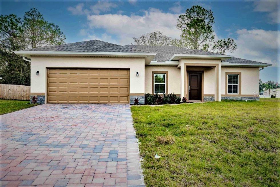 Newer North Port Home built to new hurricane standards to protect you and your family. This is a very attractive newer home in a convenient area of North Port to get on I-75 and built to new hurricane
standards to protect you and your family. You'll drive up a paver driveway and enter the front door to a spectacular great room that incorporates the kitchen and a special dining area. The kitchen includes stainless steel appliances, such as a French-door refrigerator. The big kitchen island is also great for use as a serving bar. The kitchen counters and island are granite. There is a great kitchen pantry too! The master has a large walk-in closet and dual sinks in the primary bath with granite countertops. The second and third bedrooms are very spacious with large closets. There is an enclosed den or office off the foyer. The flooring is tile throughout. The screened lanai overlooks a large backyard. The laundry room includes a laundry sink. This is just a great house at a great price.
