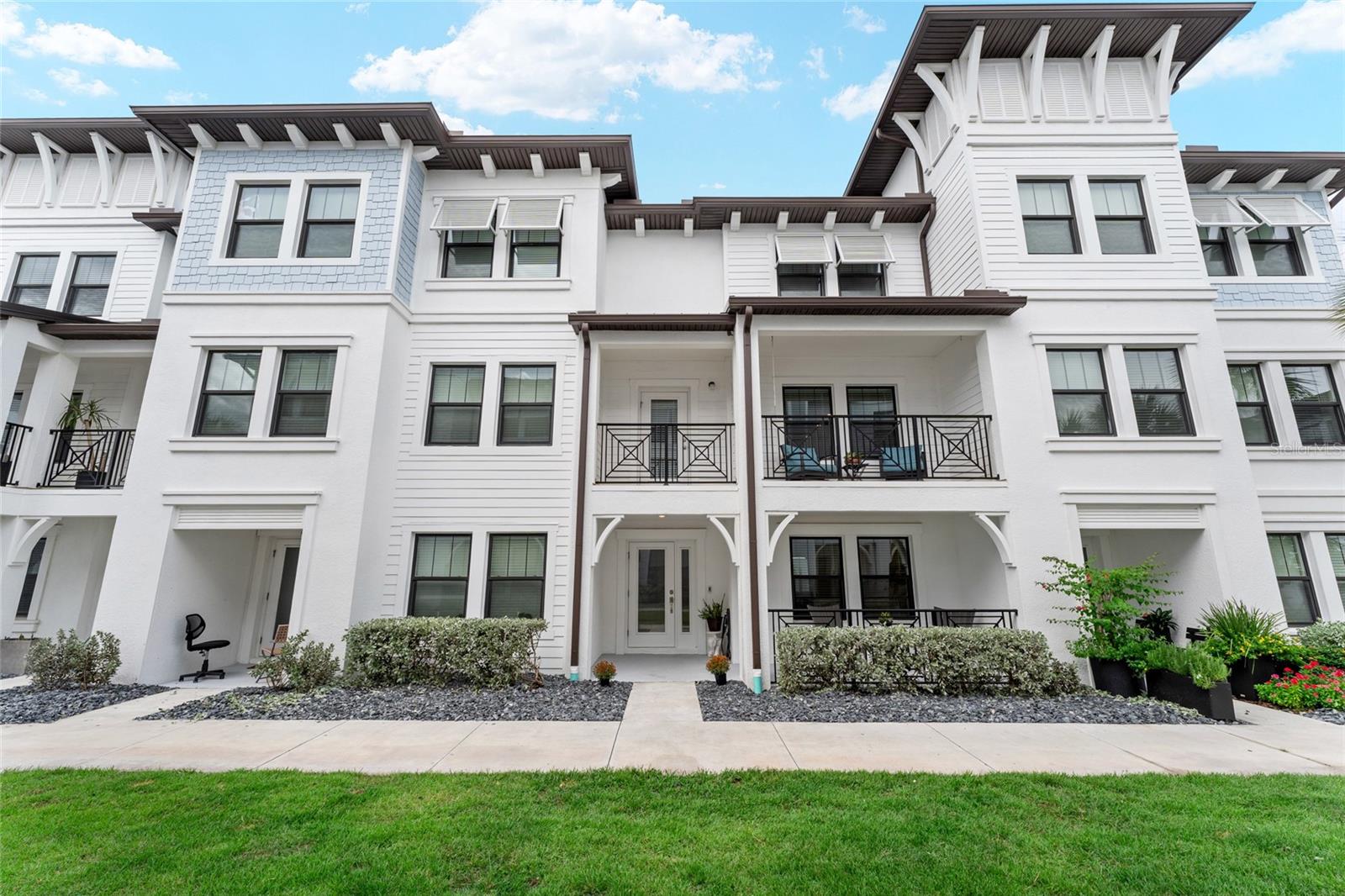 Welcome to a luxury waterfront community in Tampa’s highly sought-after Westshore Marina District! Located within Phase 2 of Inlet Shore, this residence is part of the community’s gated sector, offering added privacy and security. This 2022-built 3-story townhome offers over 2,200 sq. ft. with 3 bedrooms, 3.5 baths, a 2-car garage, and numerous upgrades. New landscaping and new drainage system installed (Sept. 2025) to add to the home’s curb appeal and function. This rare opportunity includes the option to secure a private boat dock—a new HOA project soon to be built with limited availability. The entry level features a private guest suite and a full bath. The second level is designed for entertaining with an open-concept living/dining area, a large kitchen with sleek finishes, stainless steel appliances, and a large peninsula. From here, step onto your expansive covered balcony, perfect for hosting guests or relaxing outdoors. The upper level includes a spacious primary suite with walk-in closet and spa-like bath, an additional bedroom with walk-in closet and en-suite bath, and a dedicated office space for working from home. Inlet Shore residents enjoy resort-style amenities: pool with cabanas, grilling areas, fire pit, and scenic waterfront walkways. All just steps from dining, shopping, and sunsets along Tampa Bay—centrally located between Downtown Tampa and Downtown St. Pete for the best of both worlds.