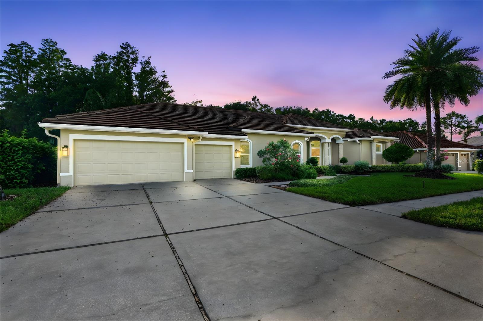 This home is a true SHOWSTOPPER, blending timeless elegance with thoughtful design in Harbor Links, one of Westchase’s most sought after gated enclaves. Step through the double doors into a grand, light filled foyer and formal living room with soaring ceilings, rich marble floors, custom iron accents, the romantic glow of crystal chandeliers, layered ceiling designs, and a tri-fold glass wall that disappears to reveal your private outdoor oasis. The chef’s kitchen is both beautiful and functional, featuring hidden panel cabinetry, a Wolf gas range, double ovens, granite countertops, and a striking metallic backsplash. The open layout flows naturally into the family room, where custom built ins and tray ceilings are sure to impress. The primary suite is a luxurious retreat with its own sitting area, pool access, and a spa bath featuring a 12 head Kohler shower AND jetted soaking tub. Just off the primary bedroom, a flex room with built-in bookshelves makes the perfect home office. 3 guest bedrooms are tucked away in their own wing (1 with ensuite), and a 5th bedroom upstairs with half bath add flexibility for guests, hobbies, or a media room. Surrounded by lush tropical landscaping, the screened saltwater pool and spa offer total privacy and year-round enjoyment. Upgrades include a 2021 FLAT TILE ROOF, IMPACT WINDOWS AND DOORS, Trane ACs (2021 and 2024), WHOLE HOUSE GENERATOR, natural gas service, 8 camera security system, mosquito control, and a 3-car garage with epoxy floors and dual Tesla chargers. Westchase offers resort style living with 2 pools (1 with a spiral waterslide), tennis, pickleball, and basketball courts, all in a TOP-RATED SCHOOL DISTRICT. Enjoy golf, local shops, dining, and year-round events in one of Tampa’s most vibrant communities. With easy access to the Veterans Expressway, airport, downtown, and Gulf beaches, it’s no surprise Westchase was named FLORIDA'S BEST SUBURB by Niche.com. Assumable 2.99 percent loan available. Ask for details.