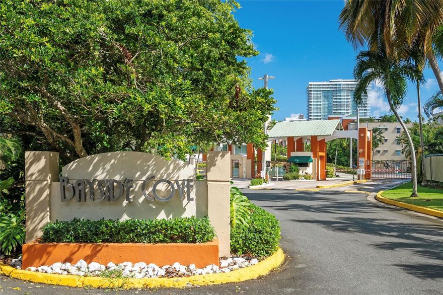 Located in one of Hato Rey’s most convenient and discreet residential enclaves, this walk-up unit at Bayside Cove offers privacy and central accessibility. The complex sits just minutes from the Coliseum, Plaza Las Américas, and the Milla de Oro banking district, yet remains tucked away from heavy traffic and noise. This particular unit is positioned toward the back of the loop for added seclusion, and its east-facing orientation overlooks a wooded area and canal with city buildings in the distance—quiet, breezy, and naturally shaded in the afternoons.  

The apartment is a third-floor, with a single-level layout, but access is easy: the front door is just eight steps above the parking level. Inside, the living, dining, and kitchen areas open to a large balcony-terrace that captures morning light and the consistent east-side breeze. The upgraded kitchen features porcelain slab countertops and an island well-suited for cooking or casual hosting. The primary bedroom includes modern wood paneling and an ensuite bathroom, while the secondary bedroom and a flexible third room—currently used as a family room with pocket doors—provide adaptable space for guests or a home office.  

Bayside Cove offers amenities that appeal to residents seeking comfort and practicality, including a swimming pool, hot tub, fitness center, racquetball court, and 24-hour security. The unit includes two tandem parking spaces within the gated complex. Overall, this is a well-located, well-designed rental option that provides privacy, convenience, and a functional layout for professionals who want to live close to the city’s main commercial hubs while maintaining a quiet home environment.