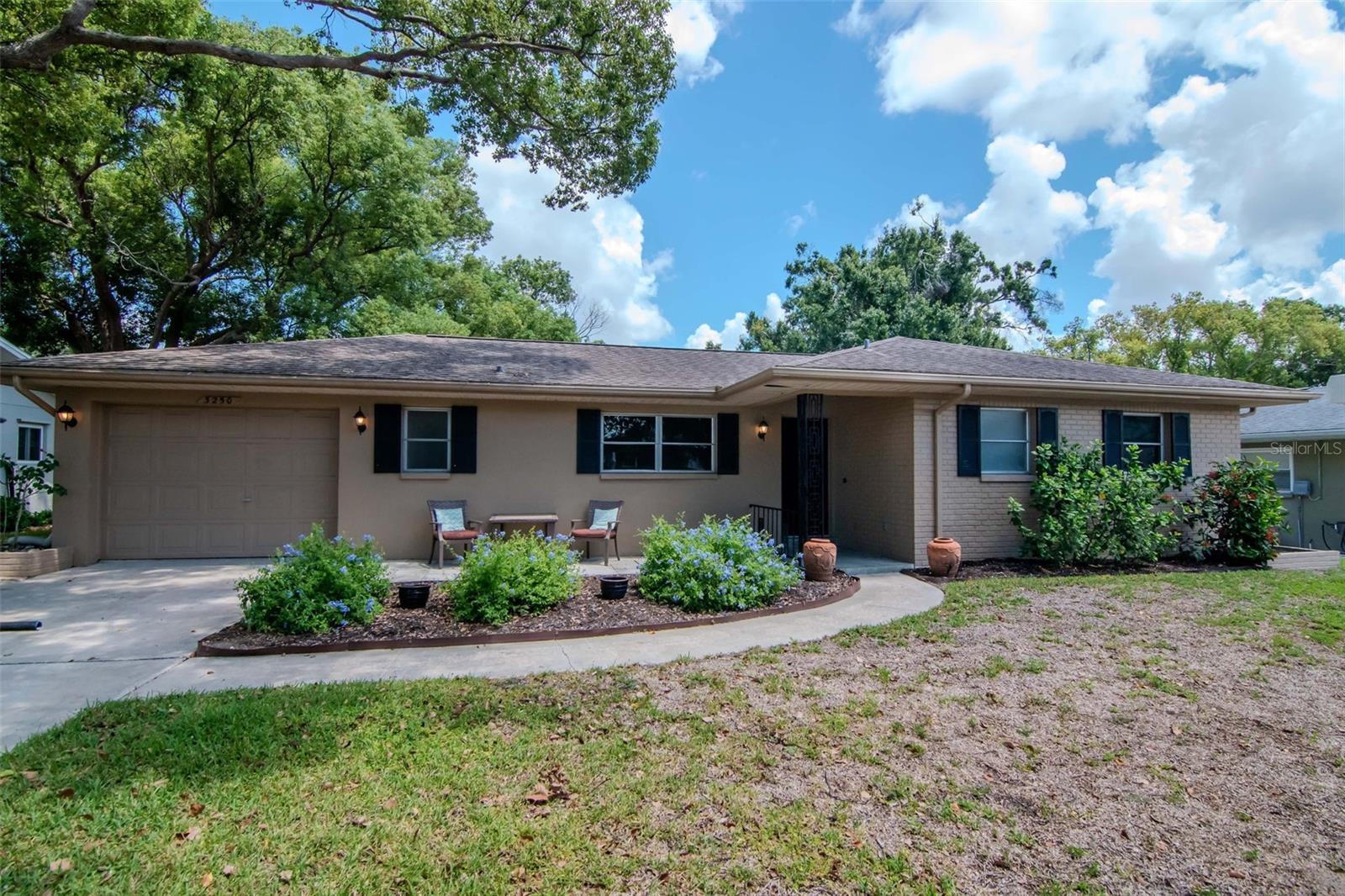 One or more photo(s) has been virtually staged. Welcome to this charming 2 bedroom, 2 bath home with an oversized 1-car garage, located in a desirable school zone and in a community with NO HOA and NO flood insurance required. The home features newly installed commercial-grade luxury vinyl plank flooring throughout, fresh interior paint, and updated wood baseboards for a crisp, modern look. Each bedroom offers its own en suite bathroom, providing two private master-style retreats. One bathroom also has hallway access, making it convenient for guests. The spacious living areas are complemented by a large backyard with plenty of room to add a pool if desired. Additional highlights include a newer A/C (2022), roof replacement in 2014, washer/dryer hookup and utility sink in the garage, a well-fed irrigation system for the entire yard (no city water cost), and functional windows throughout. The property also offers both front and back open patios, ideal for relaxing or entertaining. While the yard itself is open and easy to maintain, surrounding trees provide excellent shade. This home is move-in ready and offers an excellent opportunity to enjoy Florida living in a well-established neighborhood.