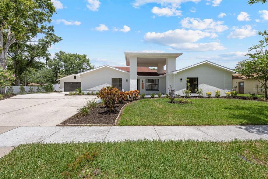Welcome to this beautifully updated home in the sought-after Carrollwood Village community of Tampa. On a large corner lot with an expansive driveway and two-car garage, this property offers impressive curb appeal and functionality. Go through the grand entrance into a spacious, open-concept layout with a split-bedroom floor plan designed for comfort and privacy. The home features five bedrooms, three and a half baths, and multiple flexible living spaces. The large primary suite includes a walk-in closet and a beautifully updated en-suite bath with a glass-enclosed shower and dual vanity. A secondary bedroom off the primary is ideal for a nursery or home office. The fifth bedroom is a standout feature, offering private exterior access and endless possibilities—ideal for a guest suite, home office, playroom, media room or in-law suite. Whether you’re accommodating extended family, need a private workspace or looking for a private playroom, this flexible space adapts to your lifestyle. The heart of the home is the modern kitchen, complete with stainless steel appliances, hood vent, quartz countertops and backsplash. Enjoy meals in the formal dining room, relax by the modern fireplace in the family room, or entertain in the formal living room at the front of the home. Multiple sliding doors lead to a screened-in pool and expansive patio, ideal for Florida living. A full pool bath adds convenience, and the oversized laundry room includes cabinetry for storage. In a vibrant community with access to parks, playgrounds, tennis and pickleball courts, basketball, walking trails, and the Carrollwood Village Park featuring a dog park, splash pad, skate park and more. Conveniently near major grocery stores, restaurants and entertainment, with quick access to Tampa International Airport, downtown Tampa and the Gulf beaches—this home has it all!
