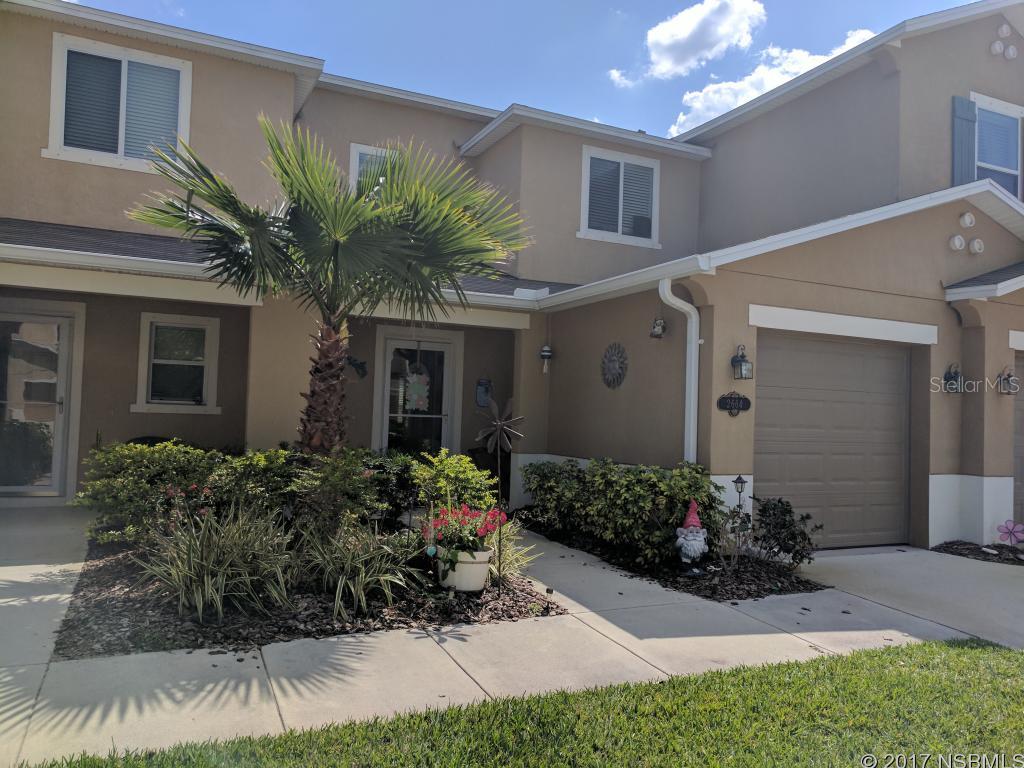 PRICE REDUCTION!! Maintenance free living at its finest! New wood floors, a lovely screened lanai and gorgeous landscaping await you in this competitively priced and meticulously maintained home in New Smyrna's The Landings at Sugar Mill. Upgraded Corian countertops and tiled backsplash complement the spacious open-concept kitchen/living/dining area. The laundry area is upstairs and it is tucked away nicely behind wooden paneled doors. Window treatments convey. Community pool and all lawn services are included in the HOA fee. HOME WARRANTY will be provided by the seller! ;Water: City