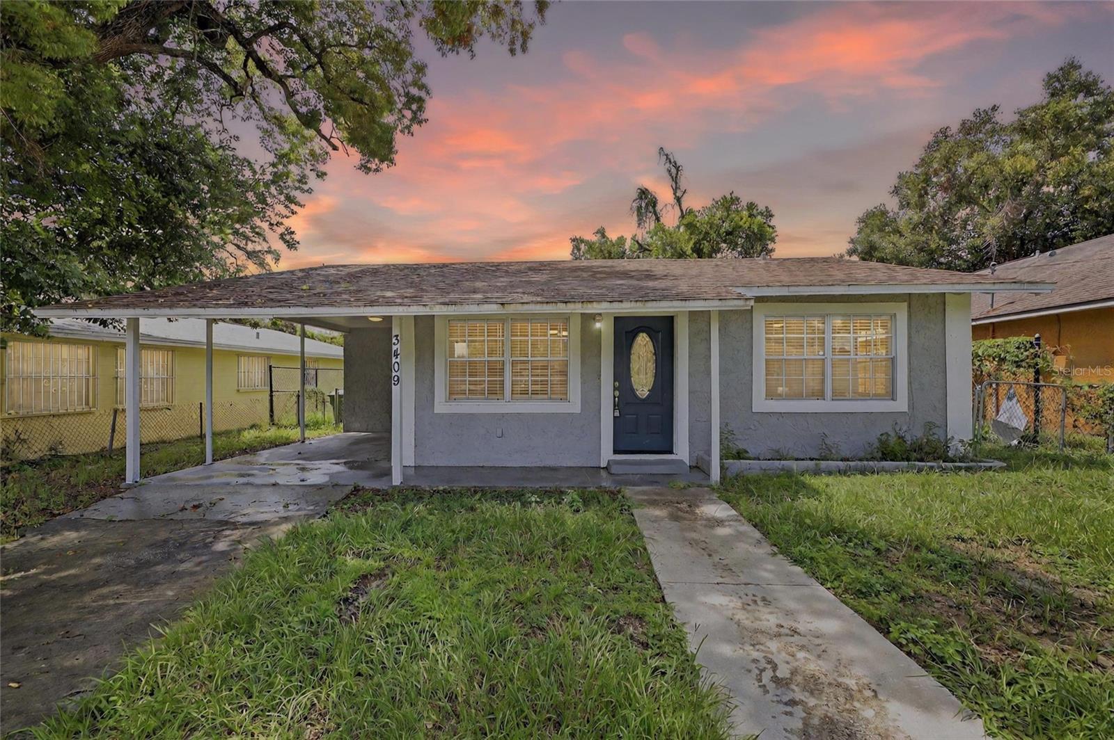 Welcome to this beautifully updated 3-bedroom, 2-bathroom single-family home in the heart of Tampa! Perfectly suited for families, first-time buyers, or anyone seeking comfort and convenience, this home offers a modern, open-concept layout that’s both functional and inviting. As you arrive, you’ll appreciate the covered carport, providing shade and protection from the elements. Inside, the spacious living and dining areas flow effortlessly into a sleek kitchen featuring stainless steel appliances, granite countertops, and soft-close cabinetry—ideal for both everyday living and entertaining. Durable laminate flooring extends throughout the home, offering a clean, contemporary look. The primary suite includes a private ensuite bathroom with a tiled shower and generous storage. Step outside to a fully fenced backyard with ample space for gatherings, playtime, or simply enjoying the Florida sunshine. With a prime location close to local amenities, this move-in-ready gem won’t last long—schedule your showing today! Virtual tour link: https://iplayerhd.com/player/video/d548dc9c-7c5d-45f4-a112-830962baf925