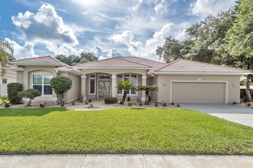 CUSTOM built home in the BARRINGTON WOODS section of Sanctuary on Spruce Creek. This home sits on an oversized lot that backs up to a wooded area, offering privacy and serenity. The cul-de-sac street is quiet and features homes with tiled roofs and large lots. This spacious home has almost 3,000 sf living area, with four oversized bedrooms, four full baths & oversized garage. Great curb appeal welcomes you and the inviting walk way leads to custom double glass front entry doors. Step in side to a bright & spacious Foyer which leads to the Dining Room, Living Room, Family Room, Kitchen & Breakfast Nook. Large windows in the Living Room overlook the Lanai & pool area & triple panel sliders in the Family Room give you access to these areas. The cook in your family will love the Kitchen that is open to the main living areas, making this home perfect for entertaining or family gatherings. All BRAND NEW Stainless Steel Appliances, lots of cabinets & counter space, a center island, pantry and "office desk" or work station are just a few of the amenities found in this beautiful kitchen. Relax at the end of your busy day in the comfort of your Owner's Suite with tray ceiling with ceiling fan, a private attached bath & sliders to access the pool area. The large bathroom features a long, double vanity, garden tub & walk-in shower. There is also a big walk-in closet for all your storage needs. One of the guest baths has access to the pool area. The Lanai is landscaped w/tropical plants & features a custom pool & spa for all your outdoor entertaining. Some recent updates include: Brand NEW 3 ton Tempstar Heat Pump installed 2019 w/a 10 year warranty, the exterior was painted May 2019, roof cleaned 2019, roof was inspected and many tiles were replaced, a new Hayward 2HP pump 2019, the interior was painted, Brand NEW SS Appliances, all 4 bathrooms have new toilets, NEW flooring throughout the entire home, new glass blocks & tile cap on pool fountain spillway, and more! ;Water: City
